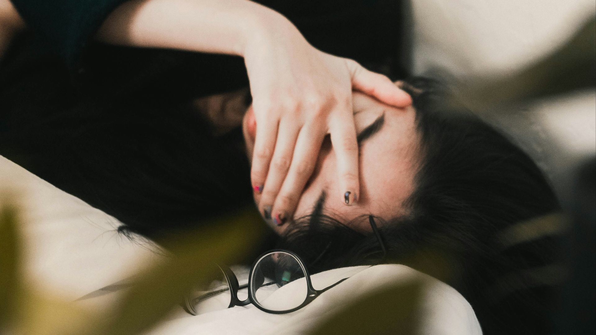 woman in black long sleeve shirt covering her face