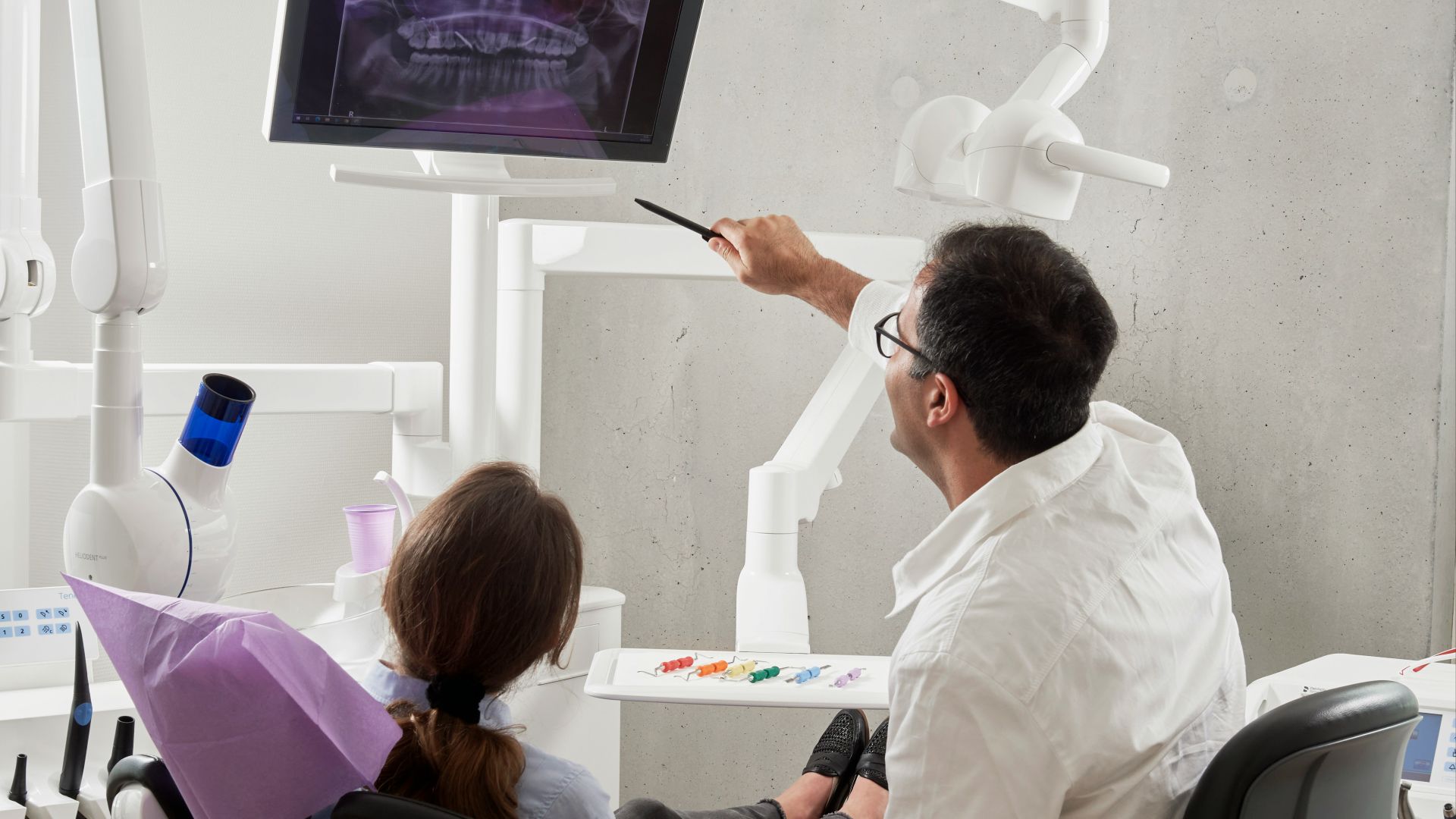 man in white dress shirt holding black pen