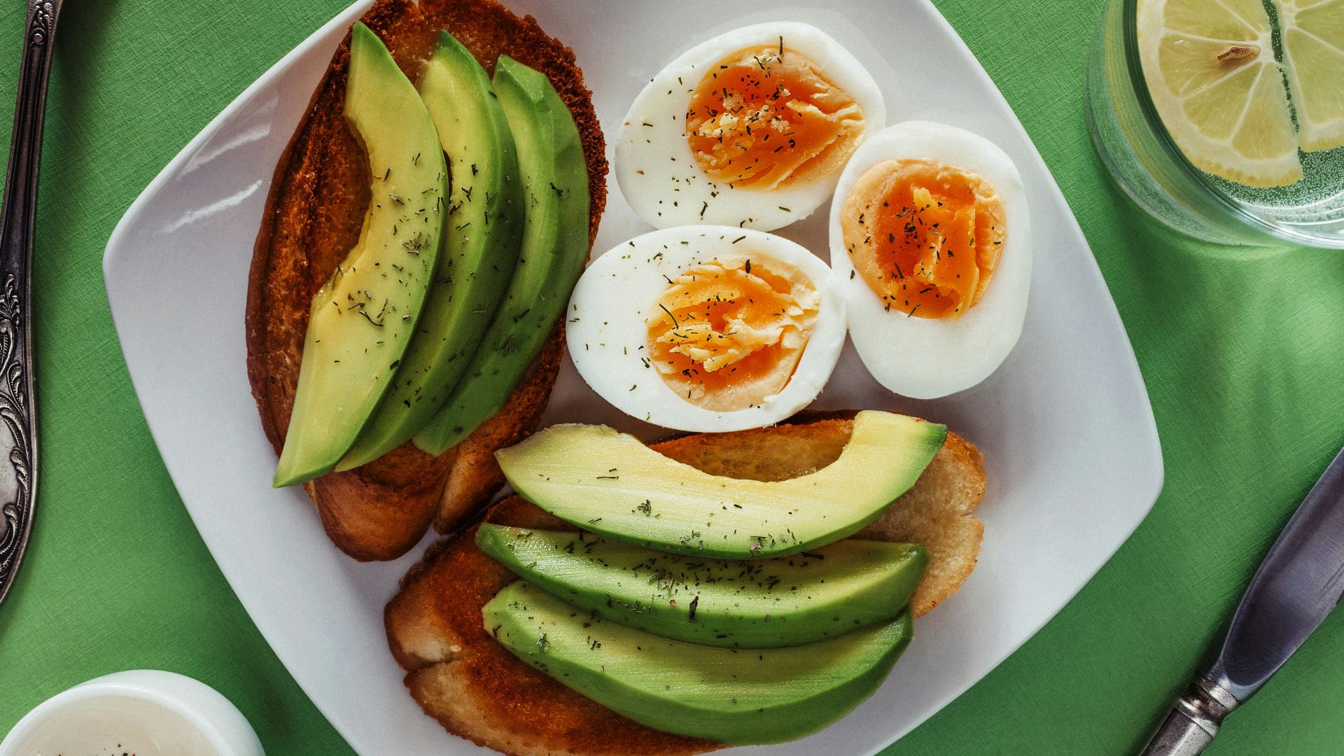 a white plate topped with eggs and avocado