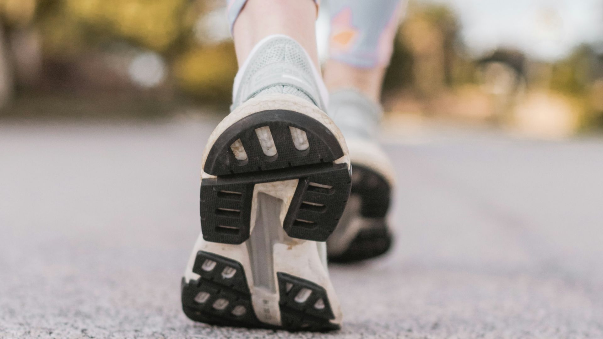 person wearing black and white nike shoes