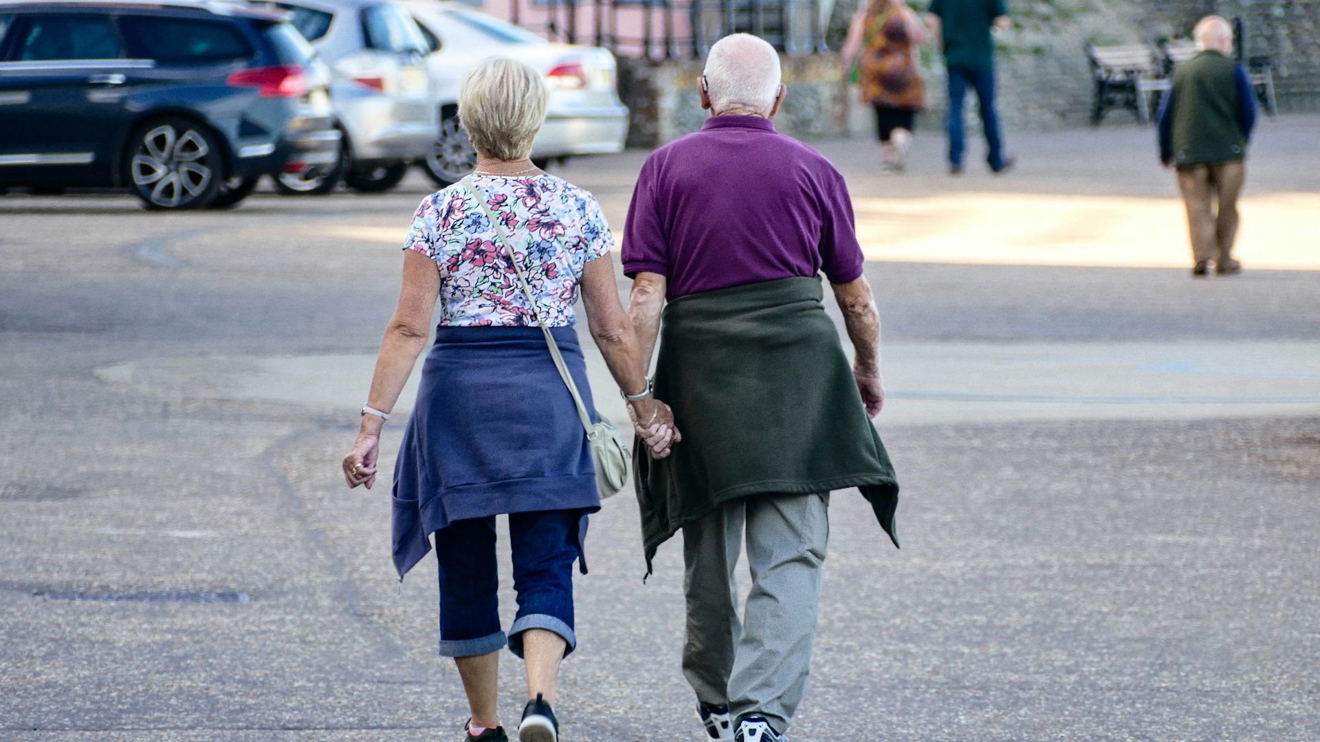 man and woman walking on the street during daytime