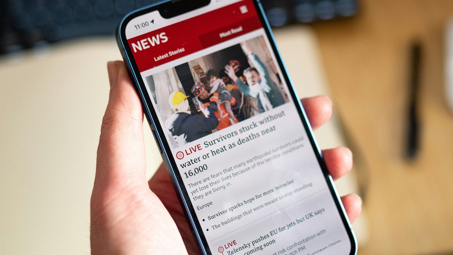 a person holding a cell phone in their hand