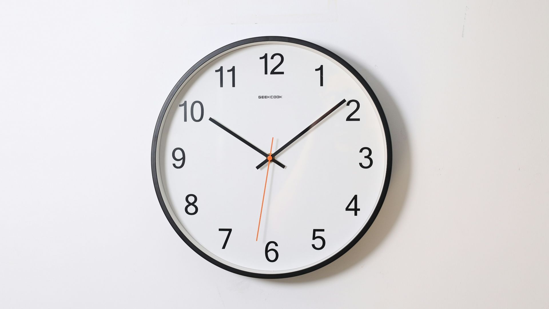 round analog wall clock pointing at 10:09
