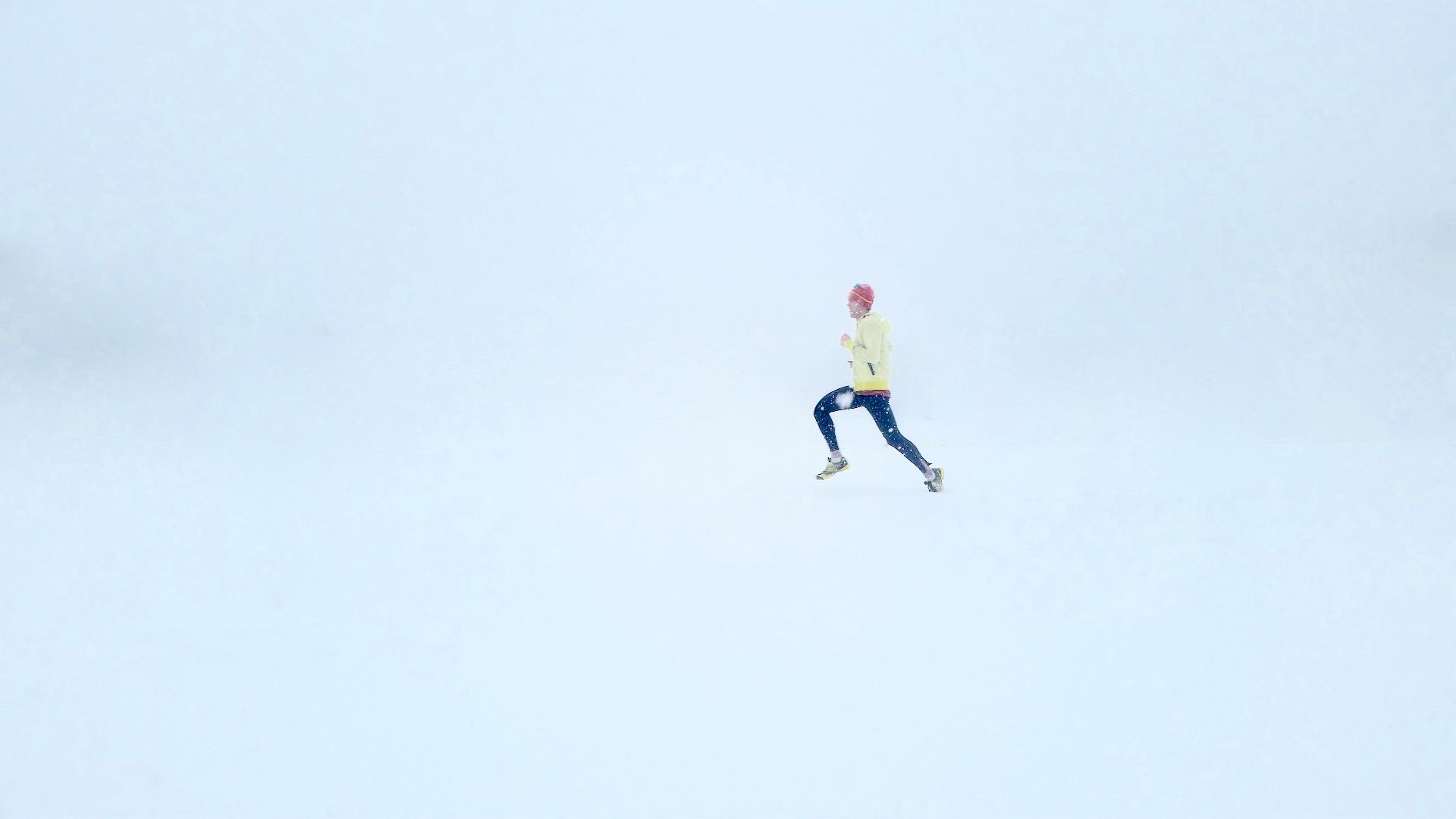 person wearing yellow jacket and black pants