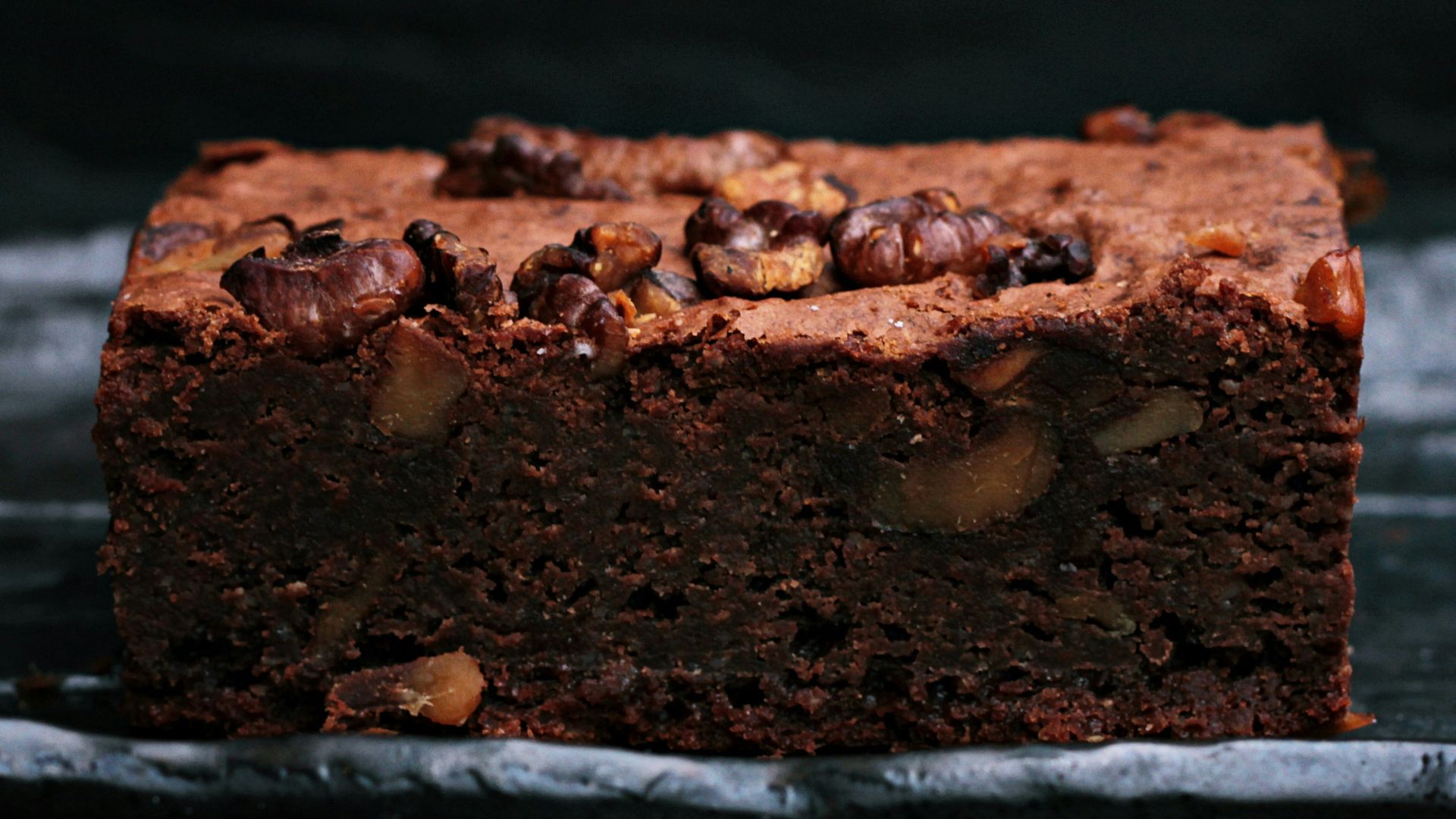 sliced baked brownies on foiled tray