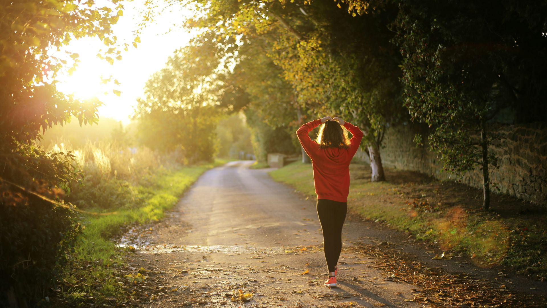 woman walking on pathway during daytime