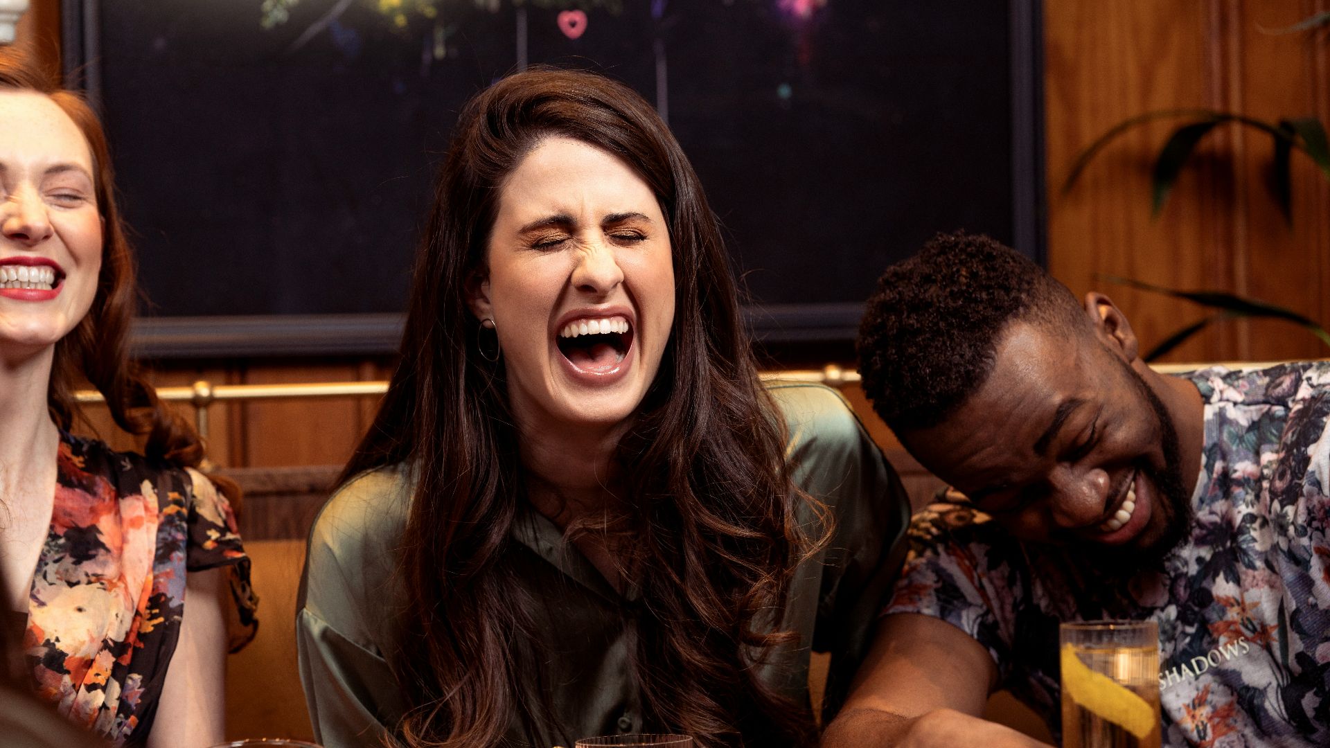 a group of people sitting around a table with drinks