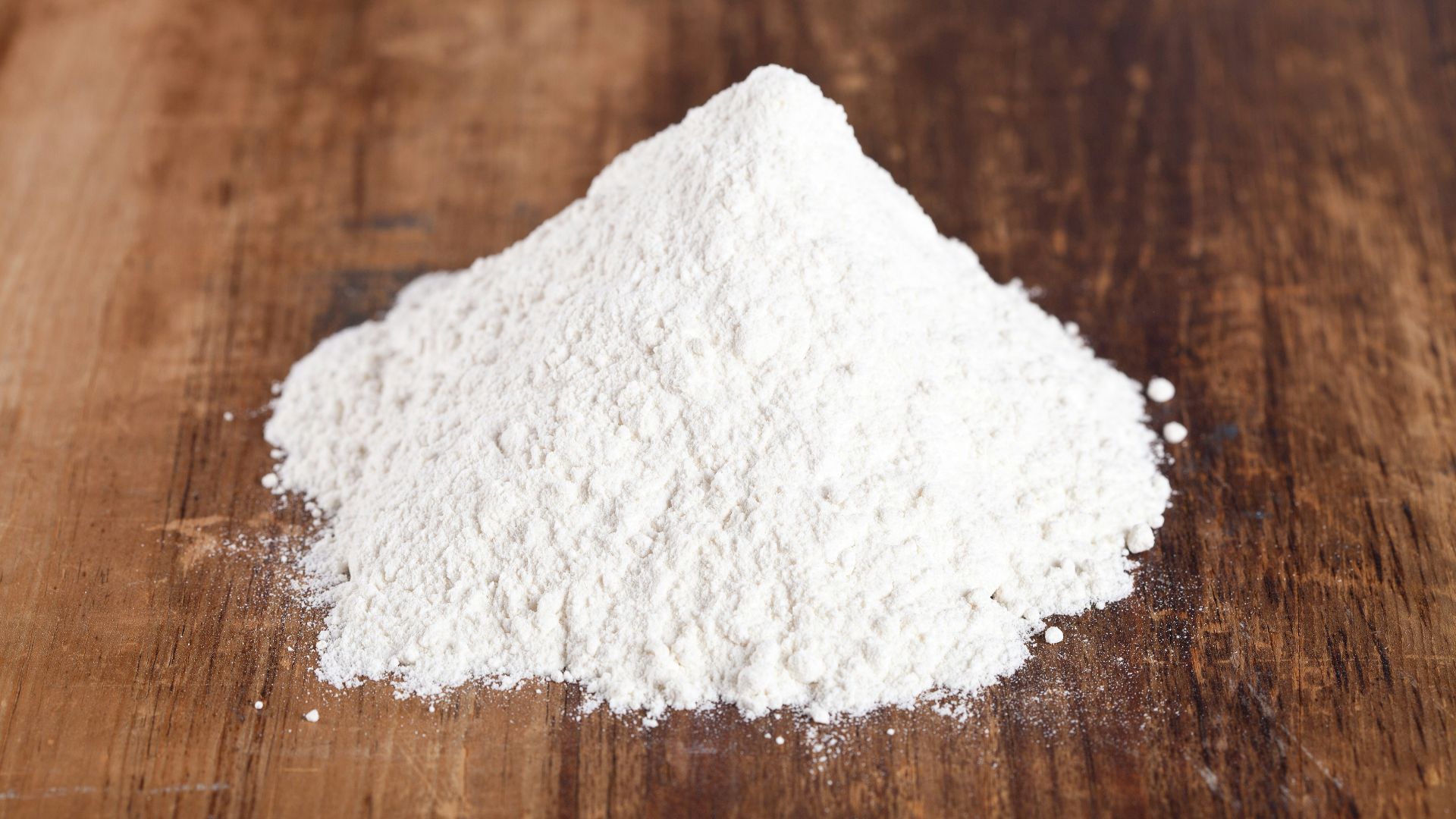 A pile of white powder sitting on top of a wooden table