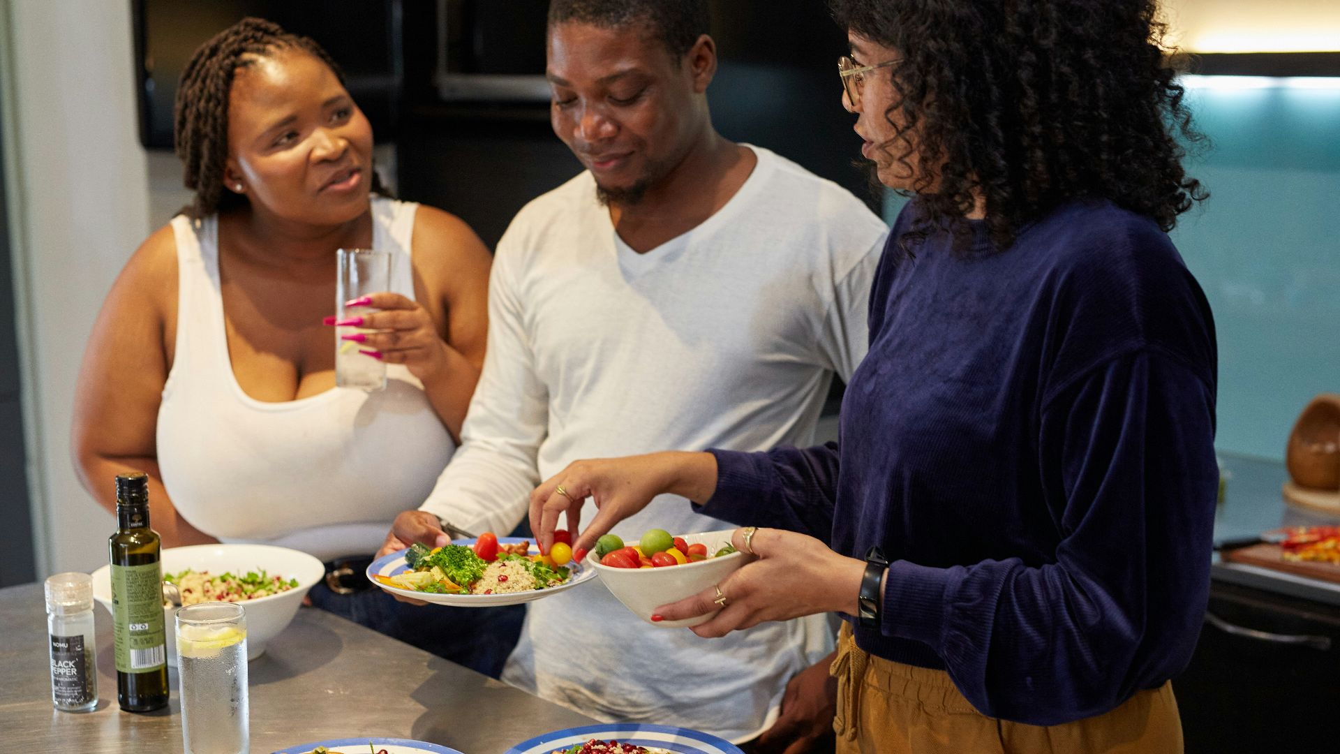 a group of people preparing food in a kitchen
