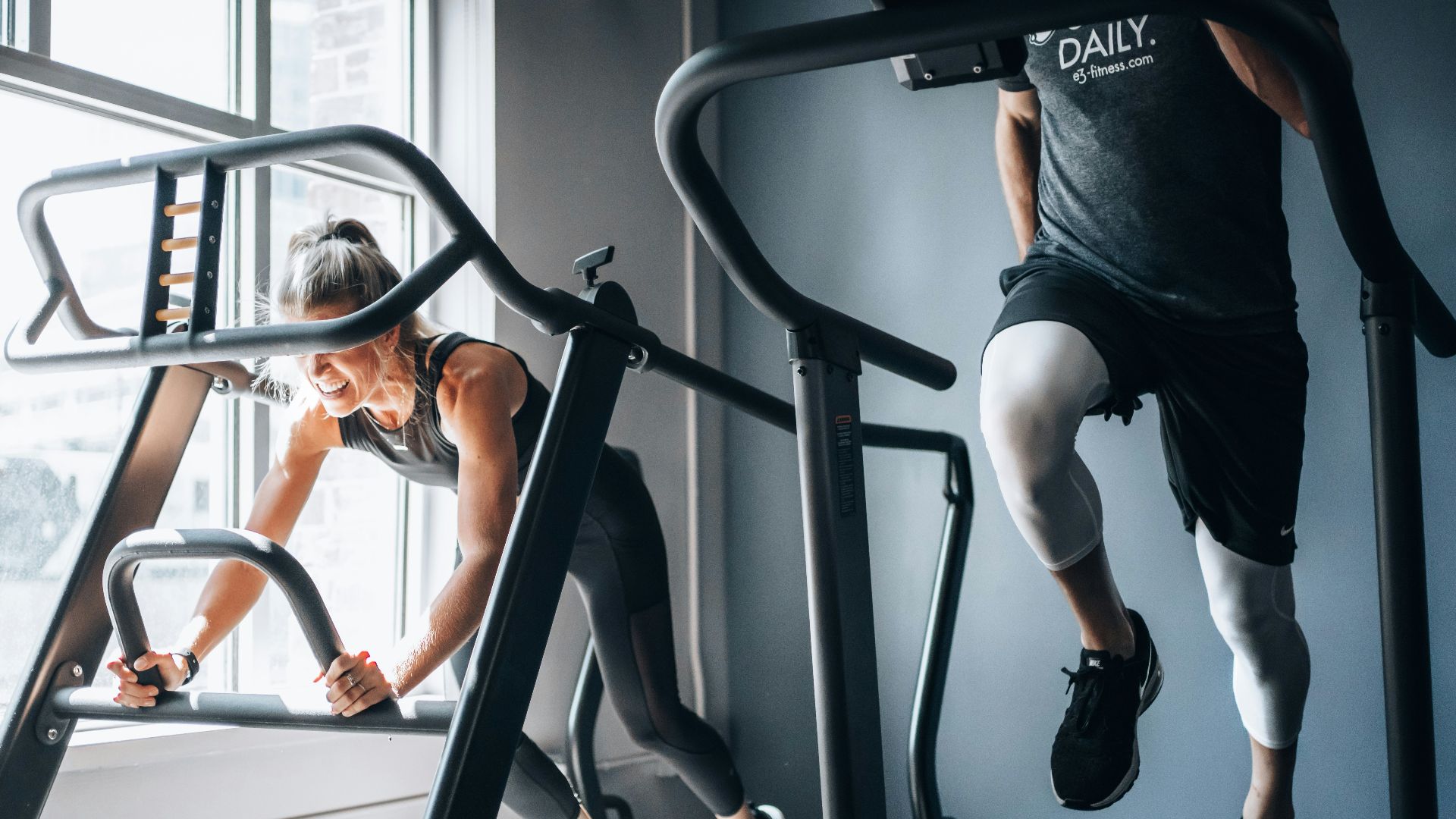woman in black tank top and black shorts sitting on black exercise equipment