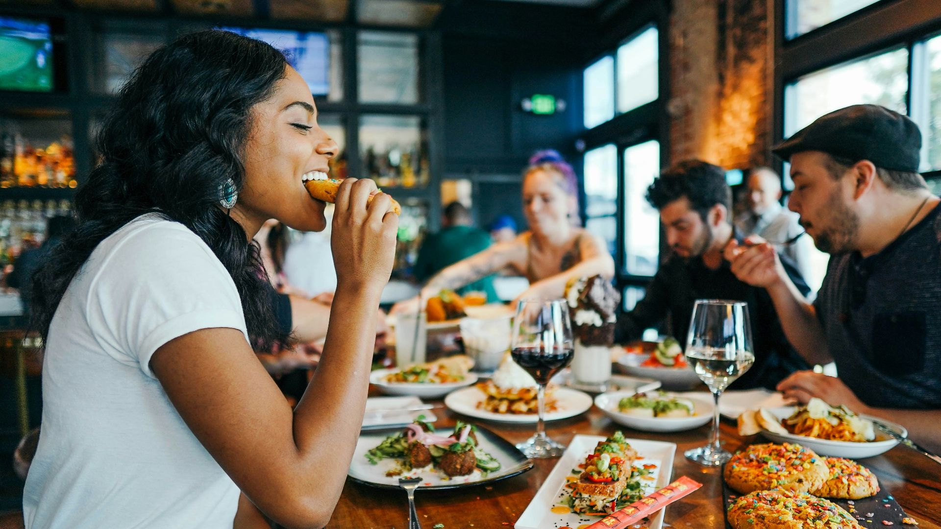 woman in white shirt eating