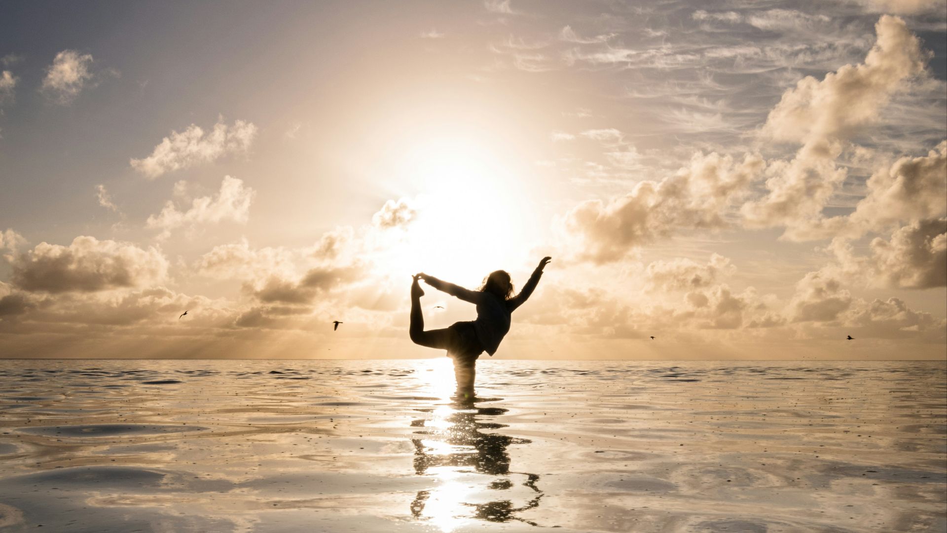 a person standing in the water doing a yoga pose