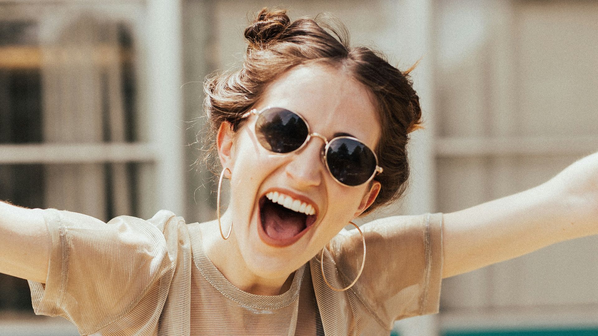 smiling woman raising hands