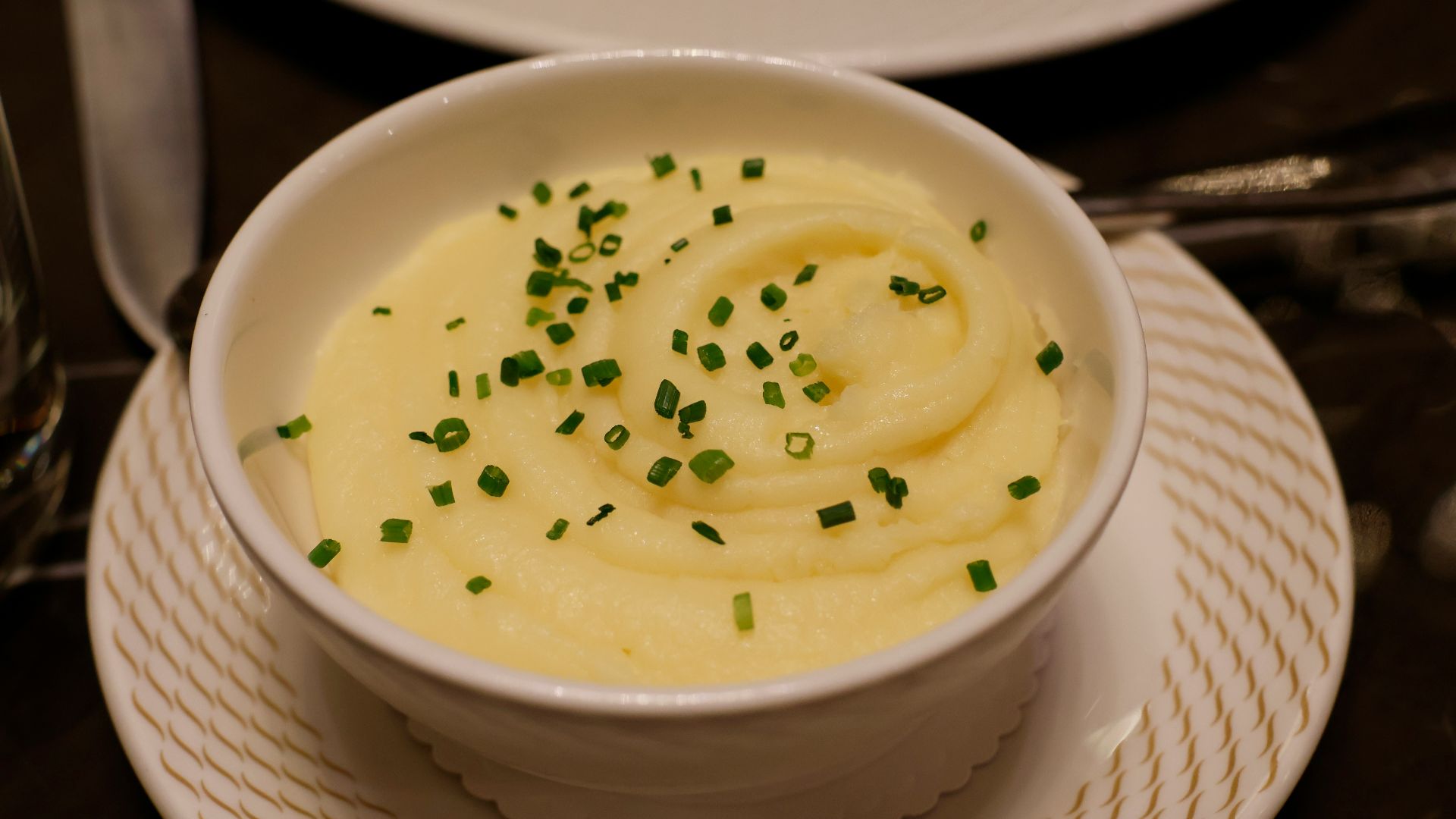 a bowl of mashed potatoes topped with chives