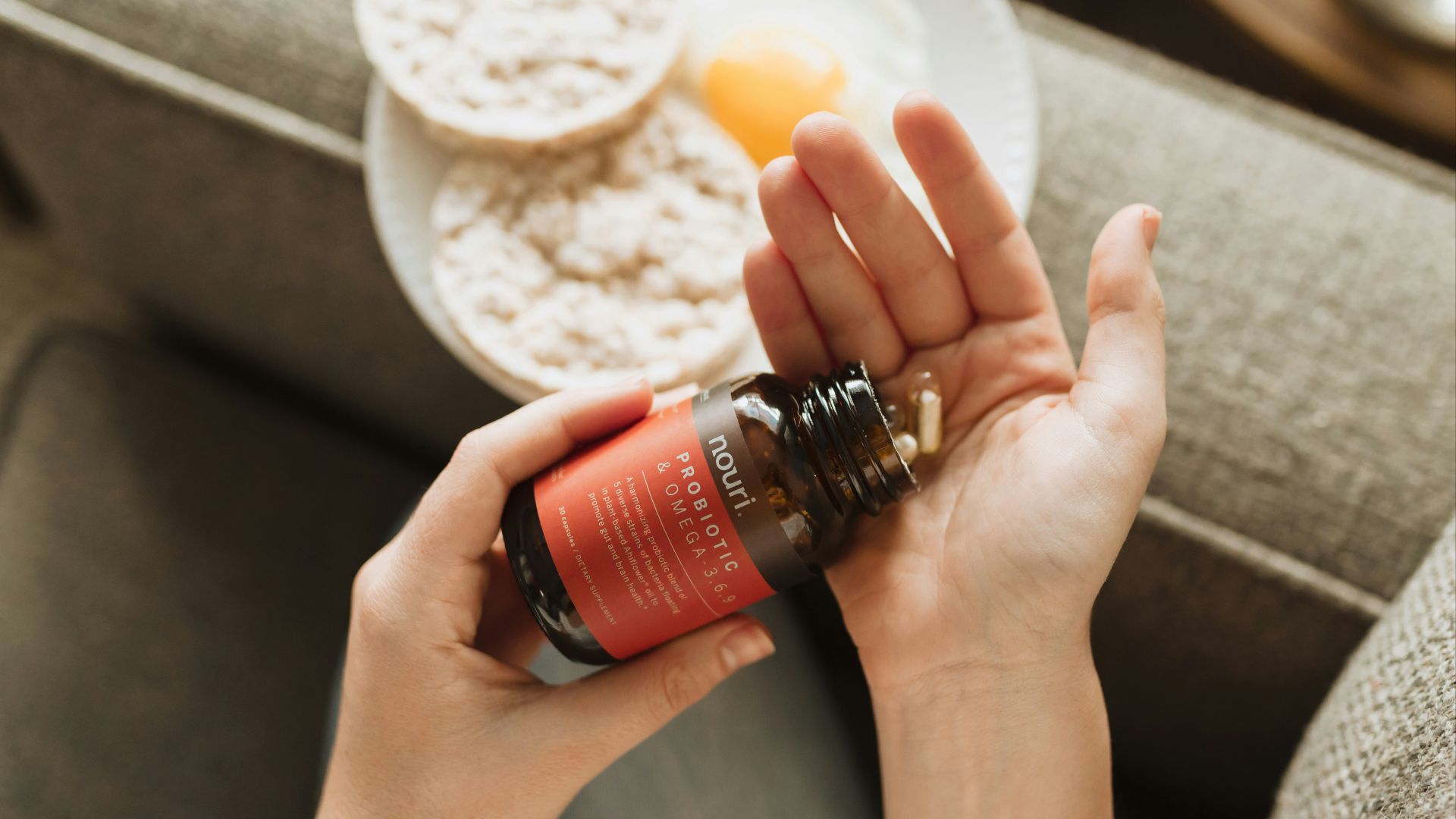 person holding red bottle
