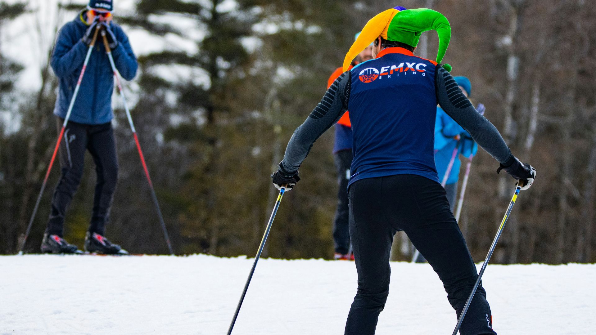 a group of people riding skis down a snow covered slope