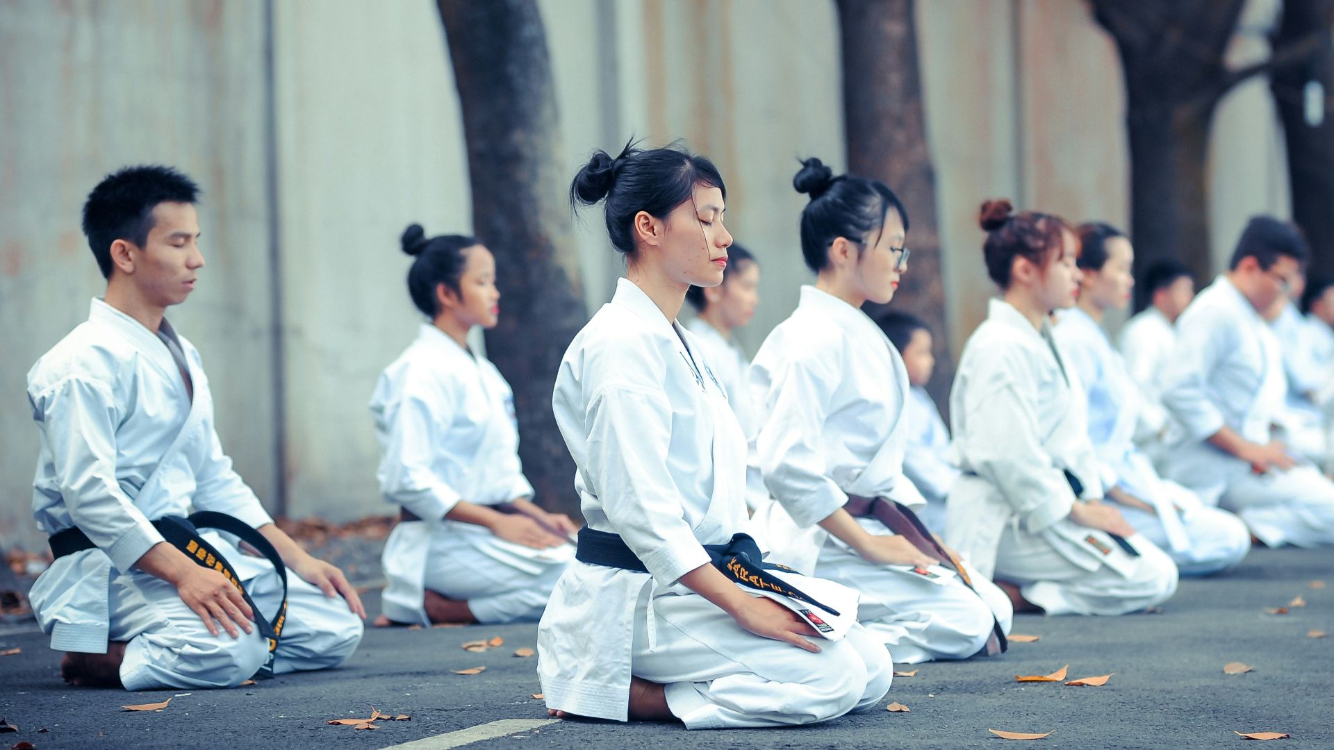 group of martial artists sitting on the grounds