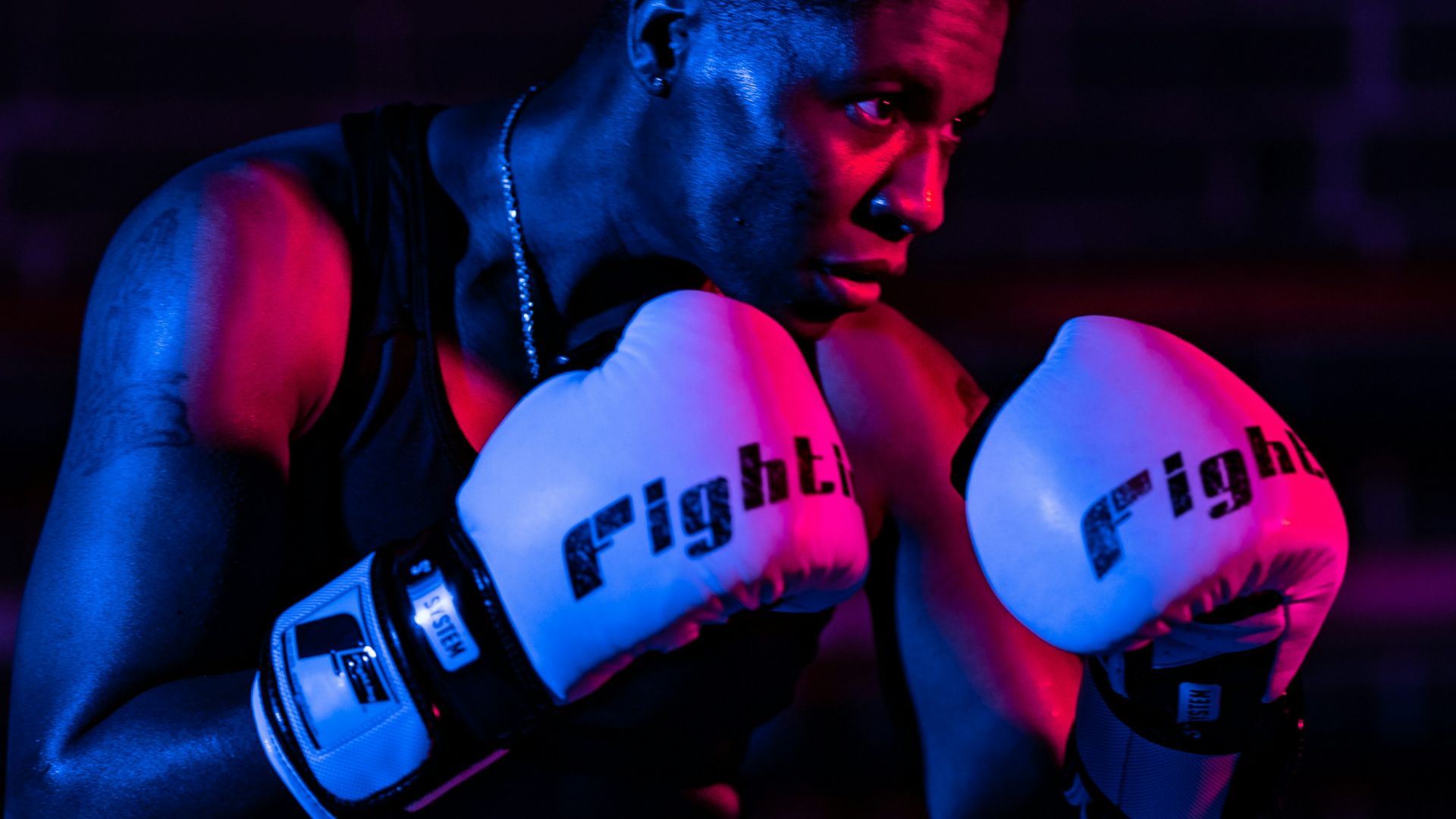 man in red jersey shirt wearing red boxing gloves