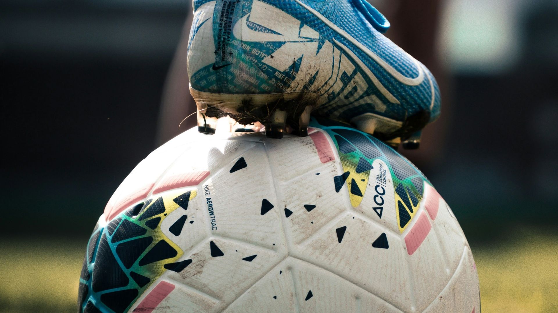 white and blue soccer ball on green grass field