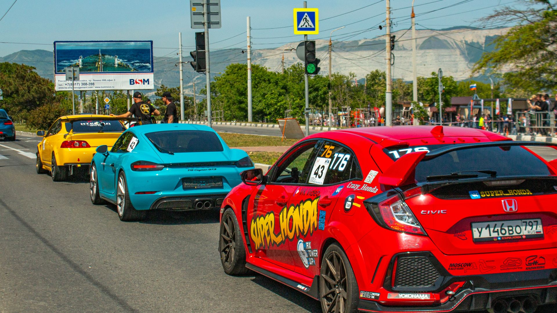 Cars driving on a road during a race.