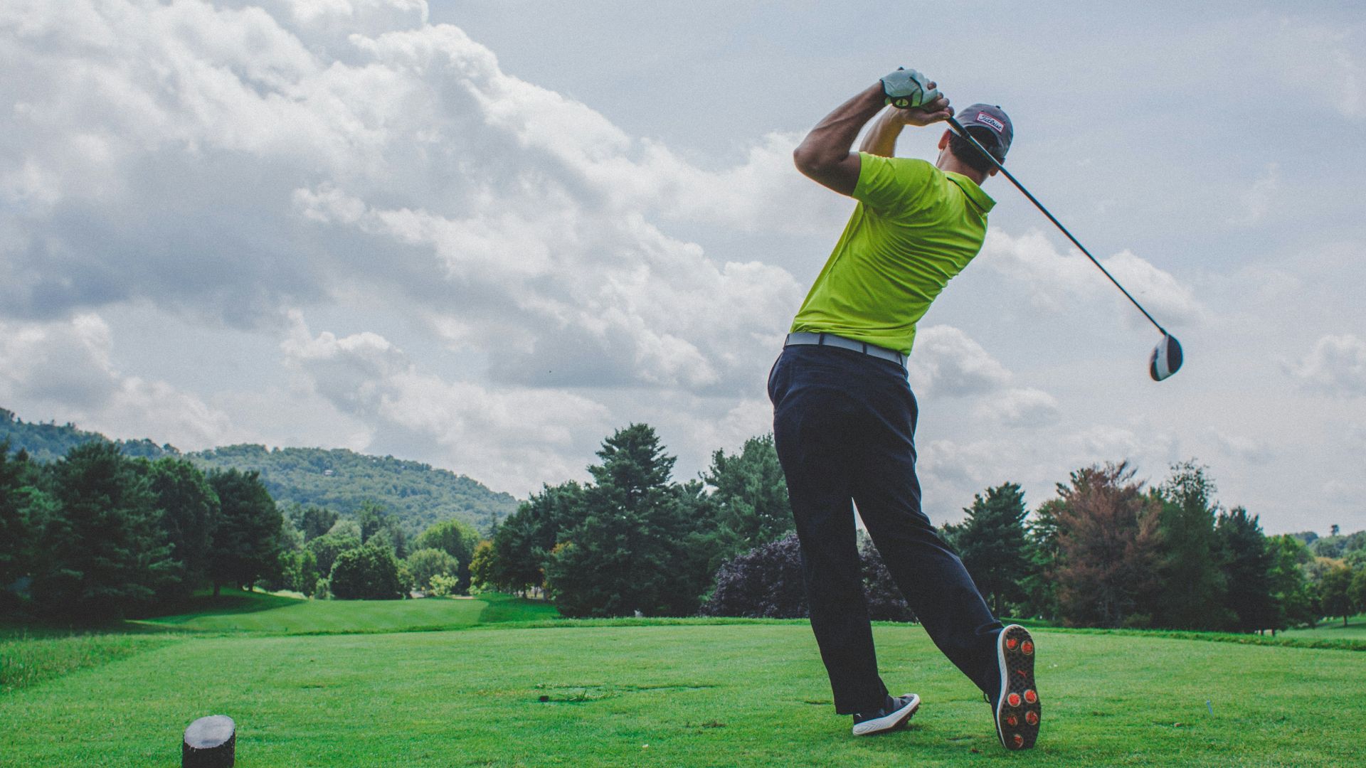 photo of man swinging golf driver