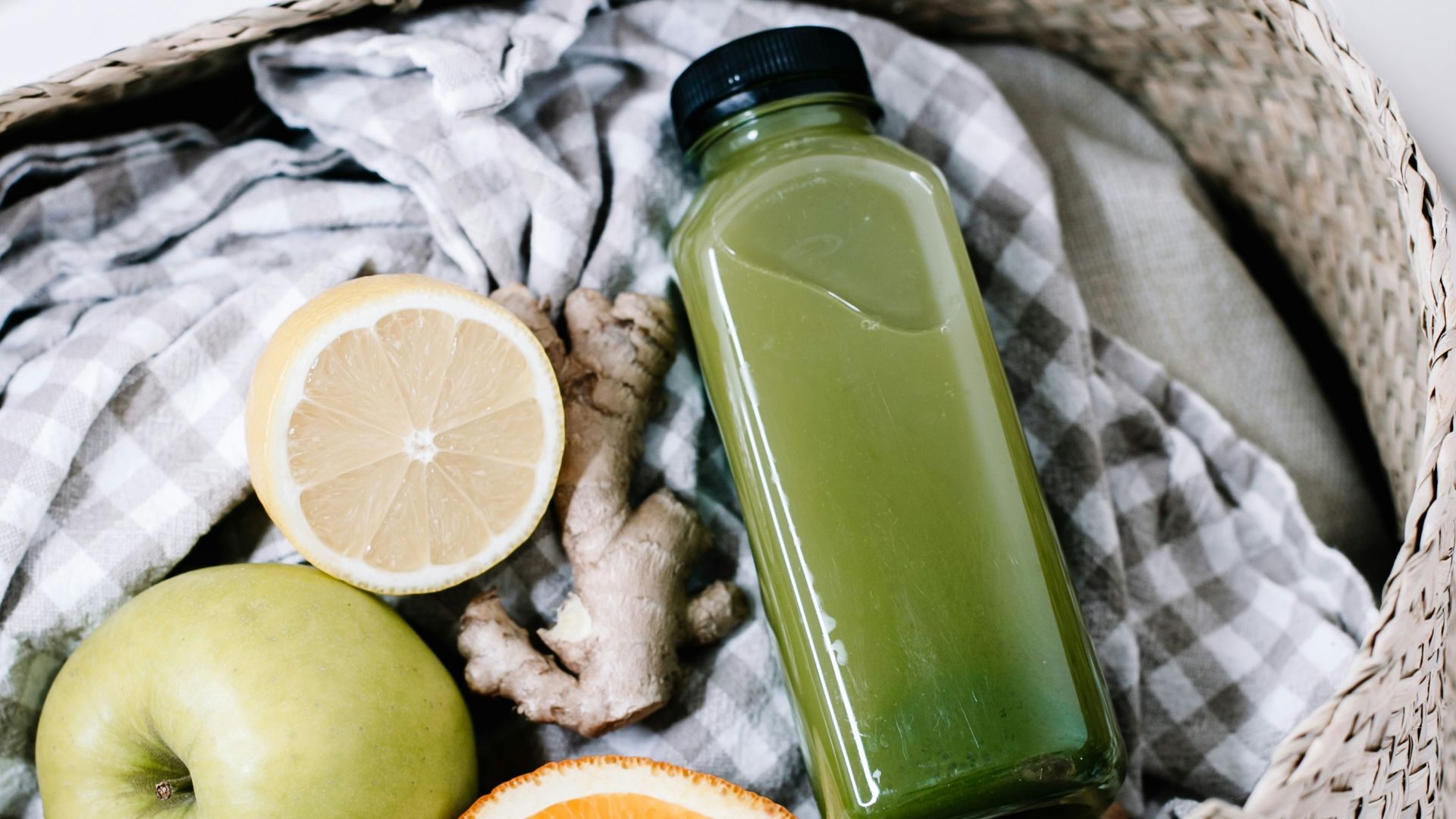 green disposable lighter beside orange fruit on brown woven basket