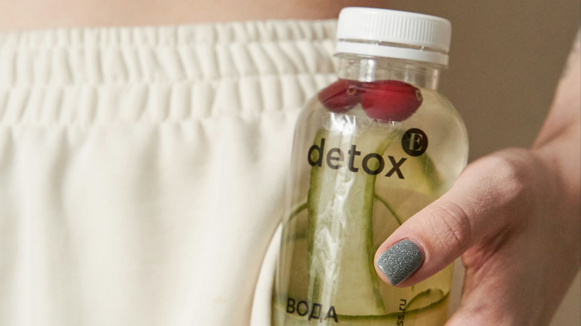 a hand holding a bottle