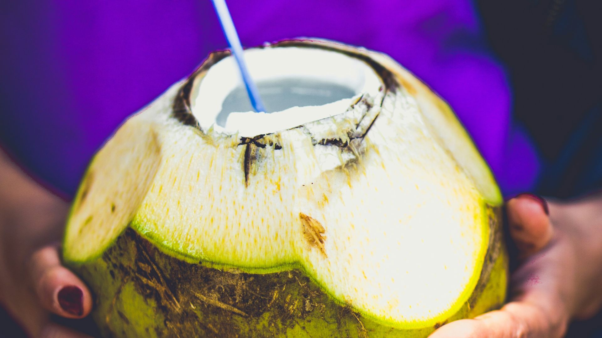 person holding coconut juice