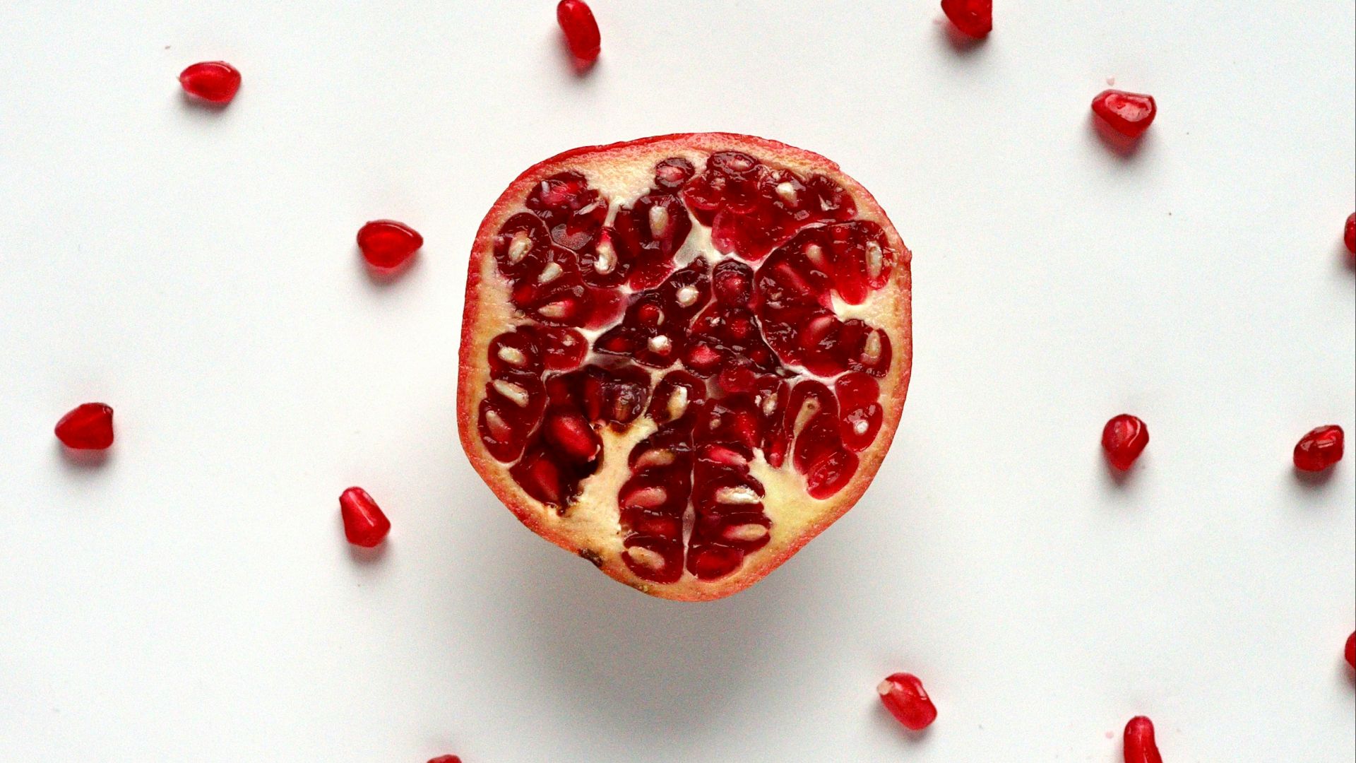 red sliced fruit on white surface