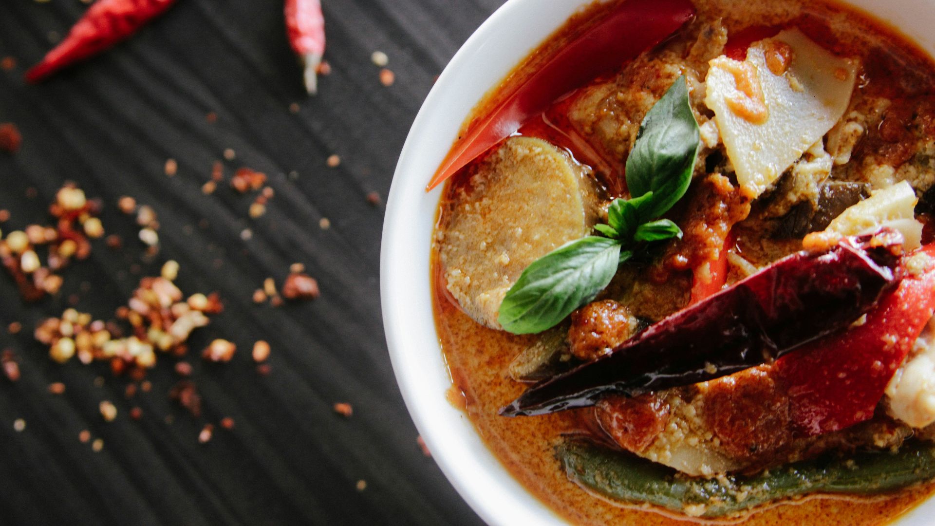 flat-lay photography of vegetable soup on white ceramic cup