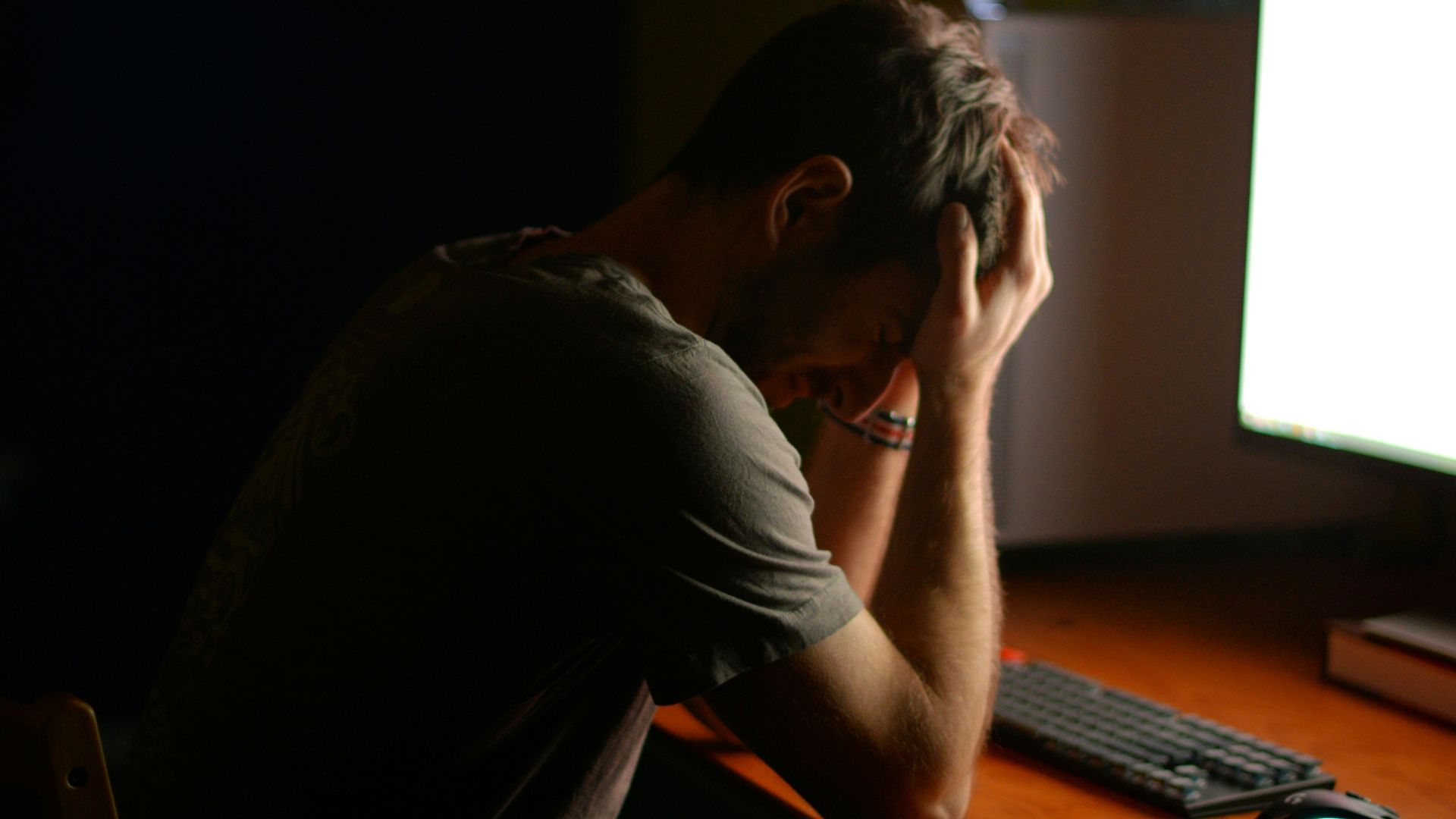 a man sitting at a desk in front of a computer