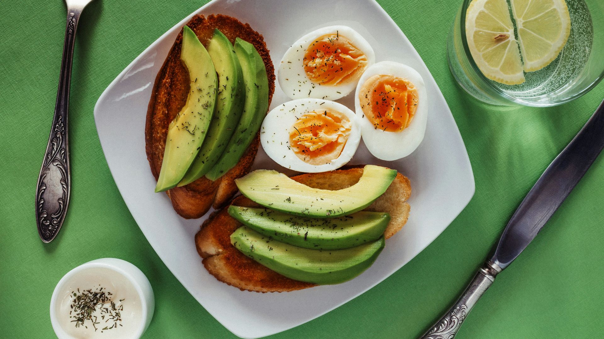 a white plate topped with eggs and avocado