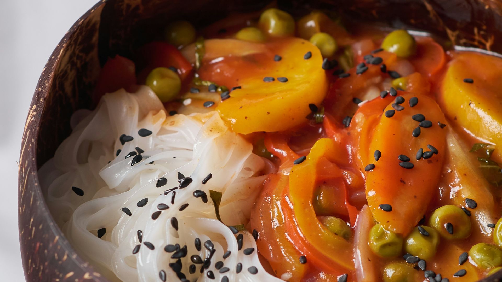 sliced carrots and onions on black and white ceramic bowl