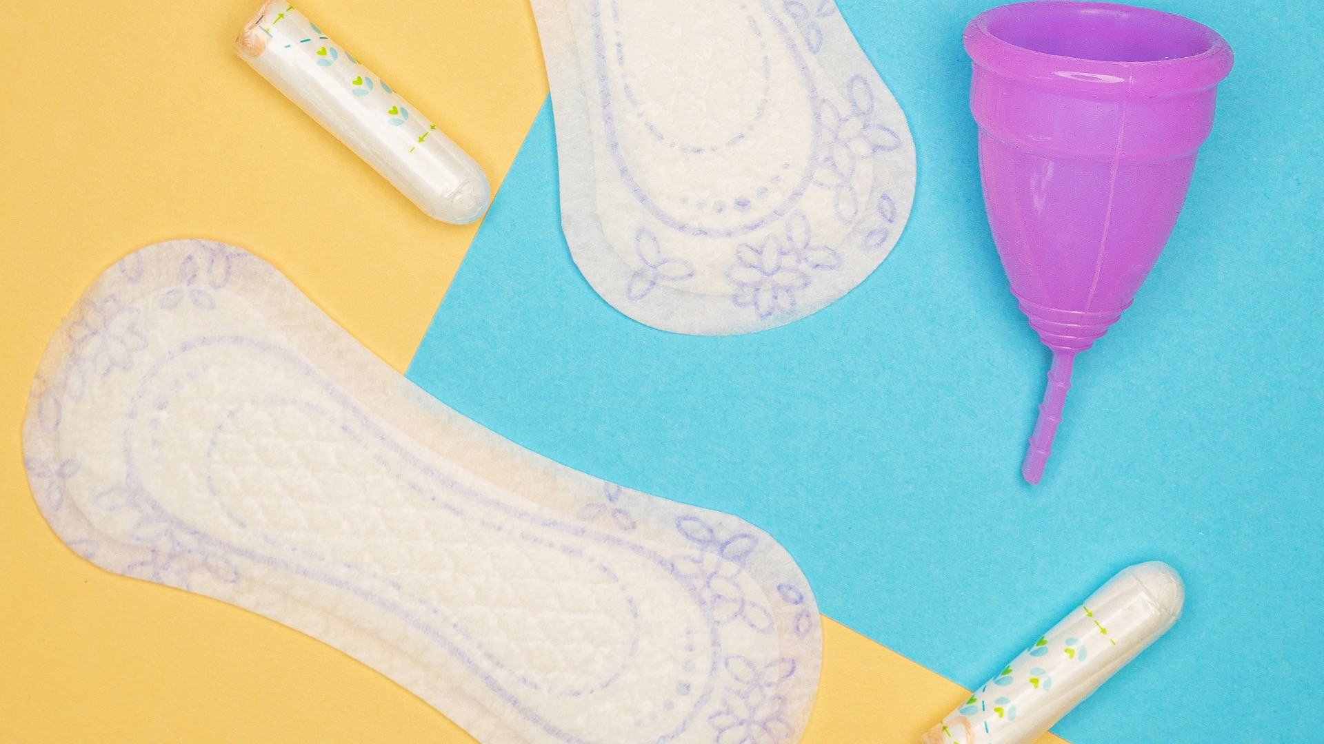 a pair of white socks and a purple cup on a blue and yellow background