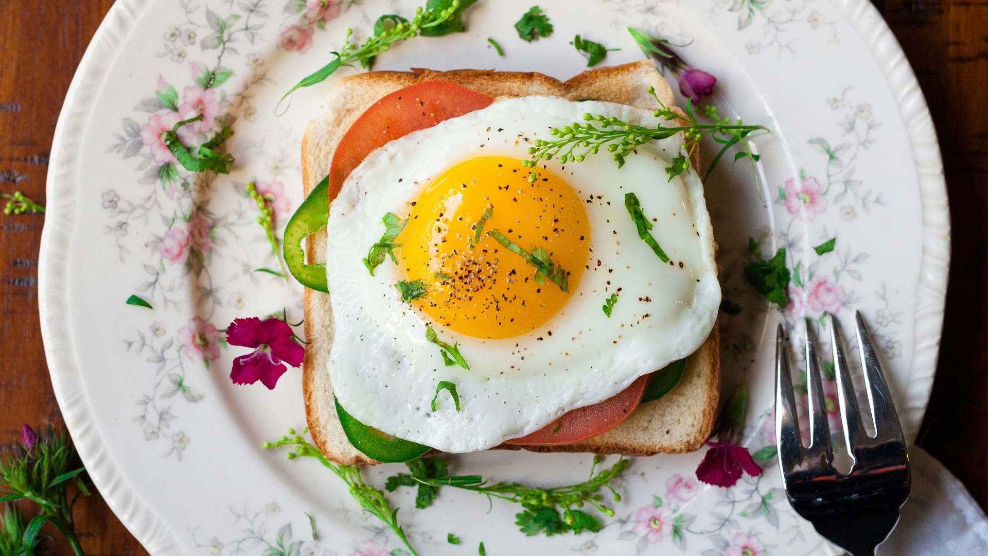sunny-side up egg with bread beside fork