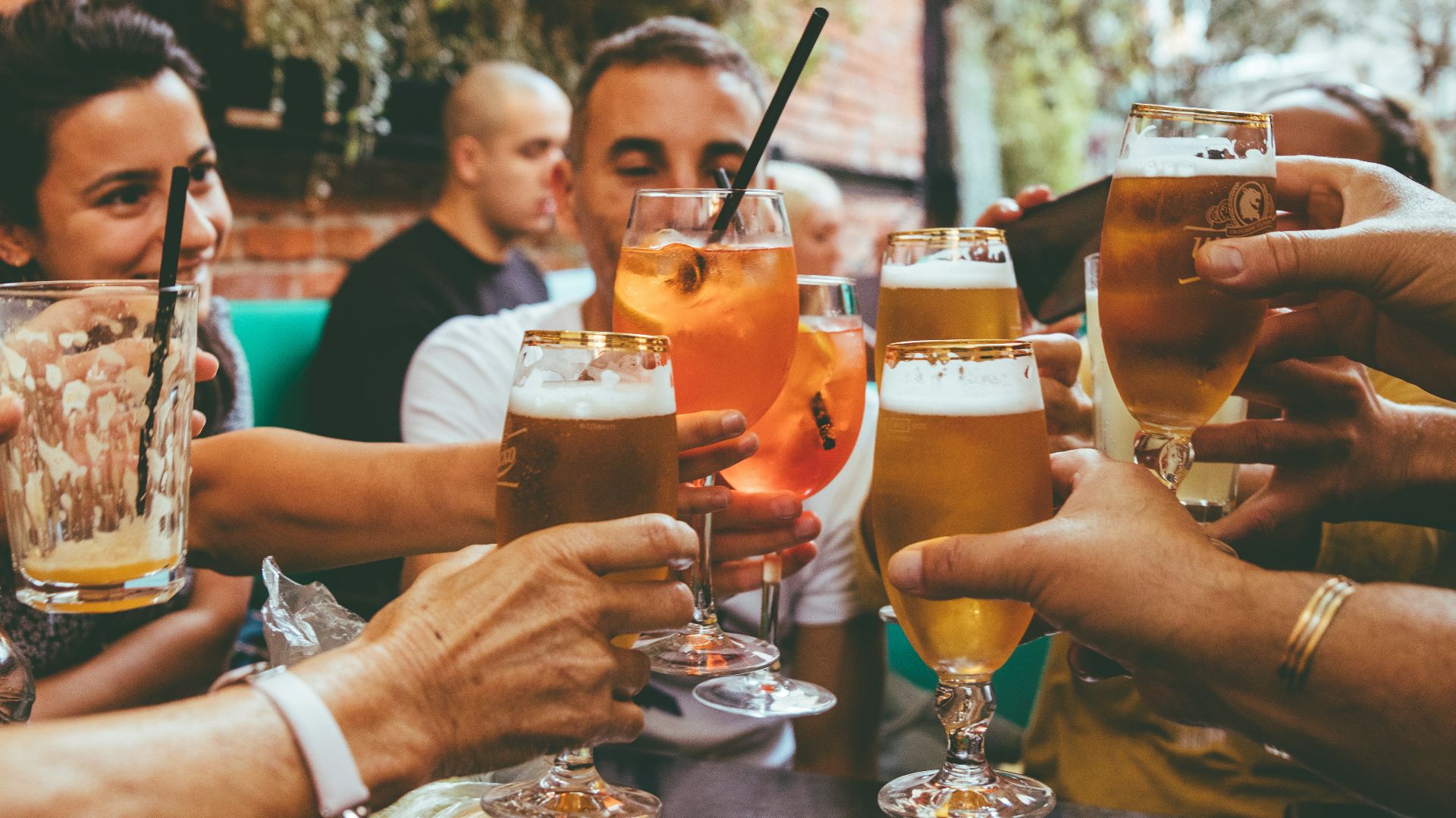 people holding drinks during day