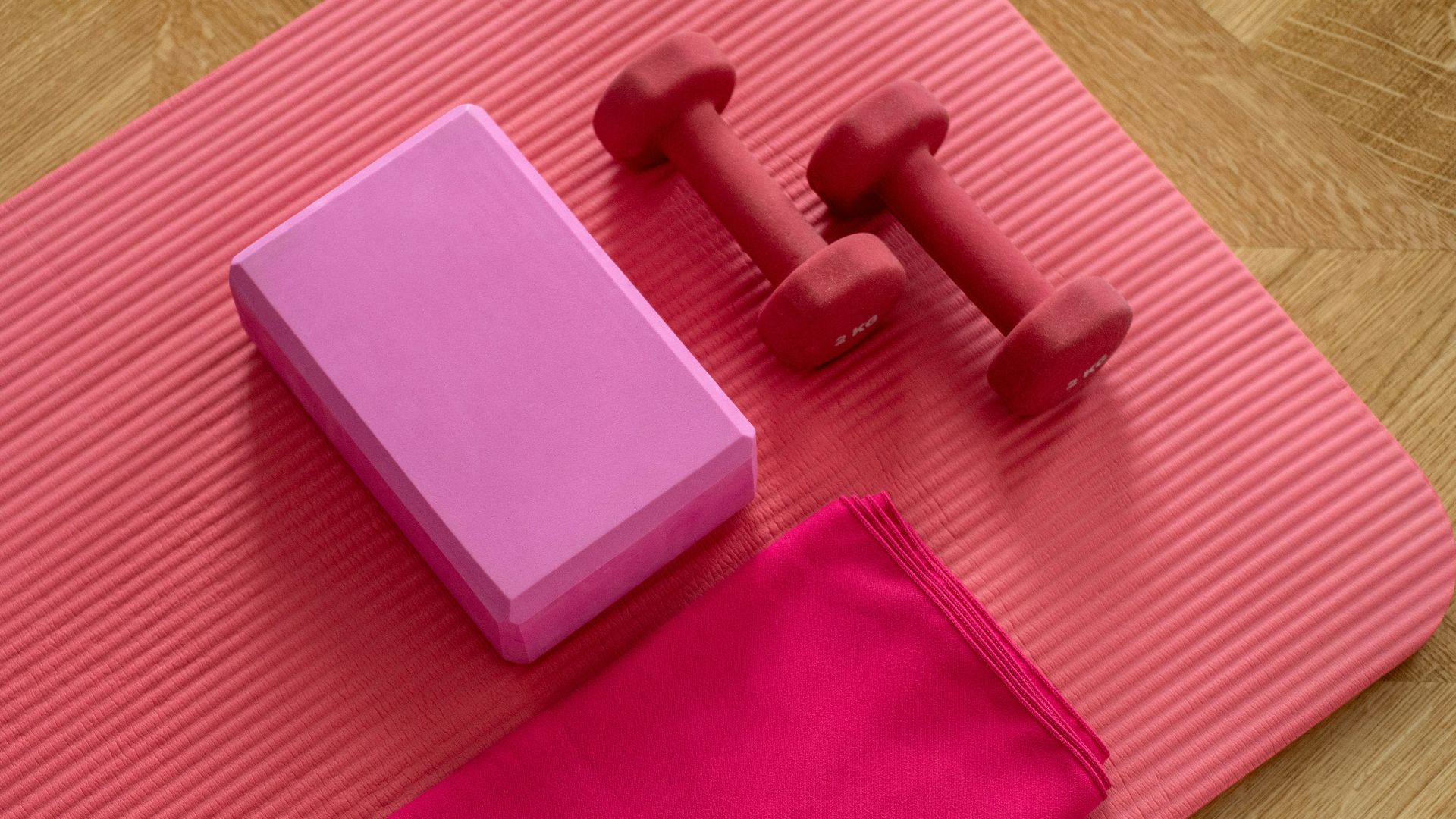 pink dumbbell on pink textile