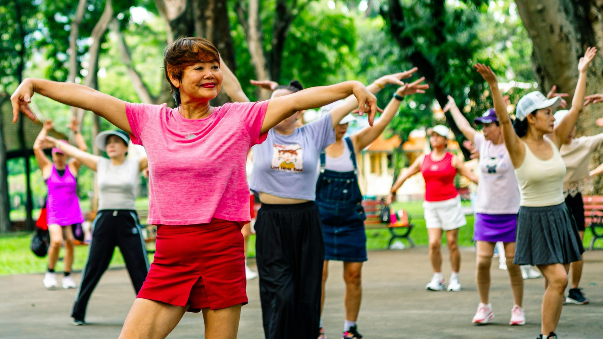 Group of women exercising together in a park.