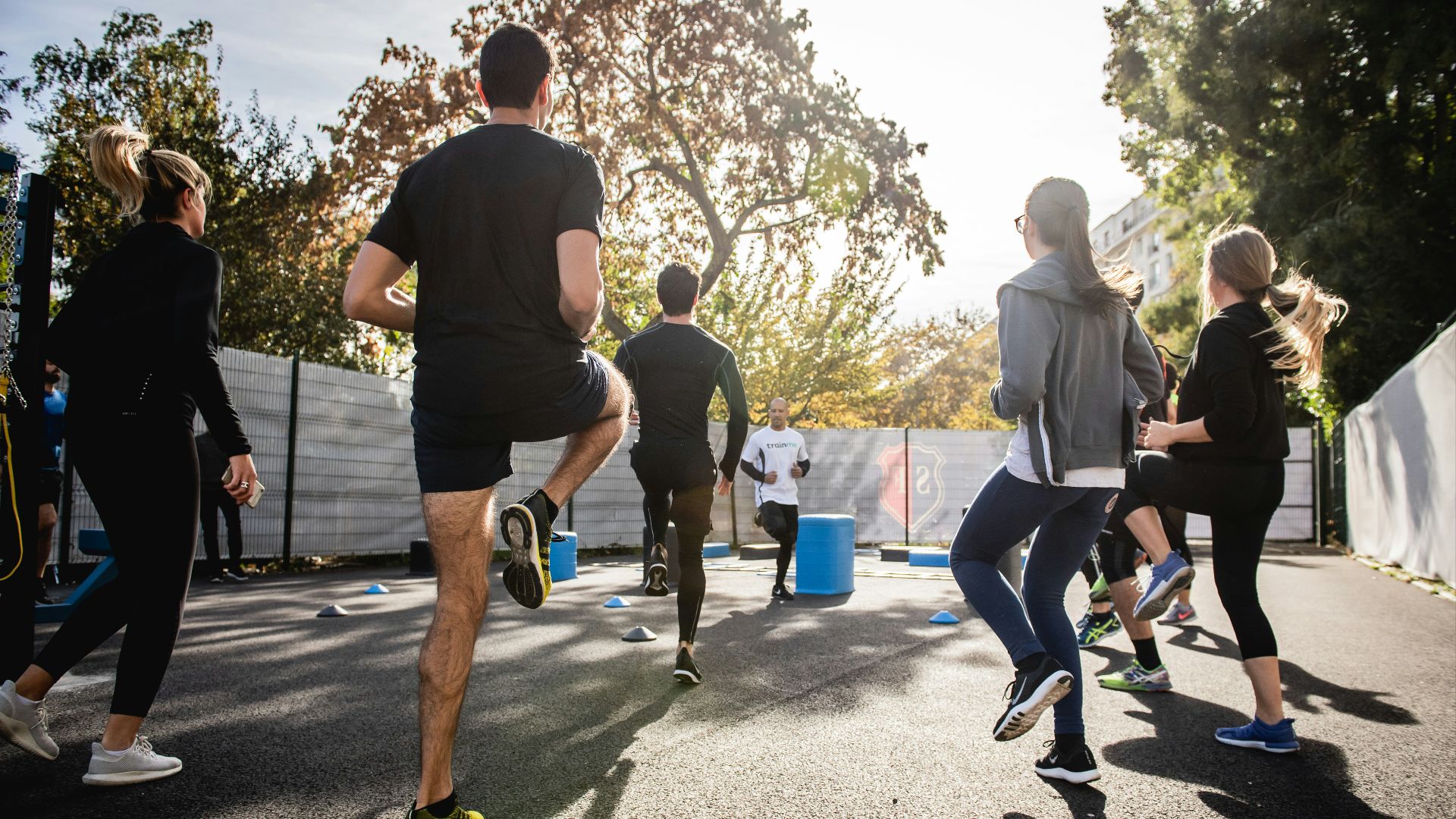 man in black t-shirt and black shorts running on road during daytime