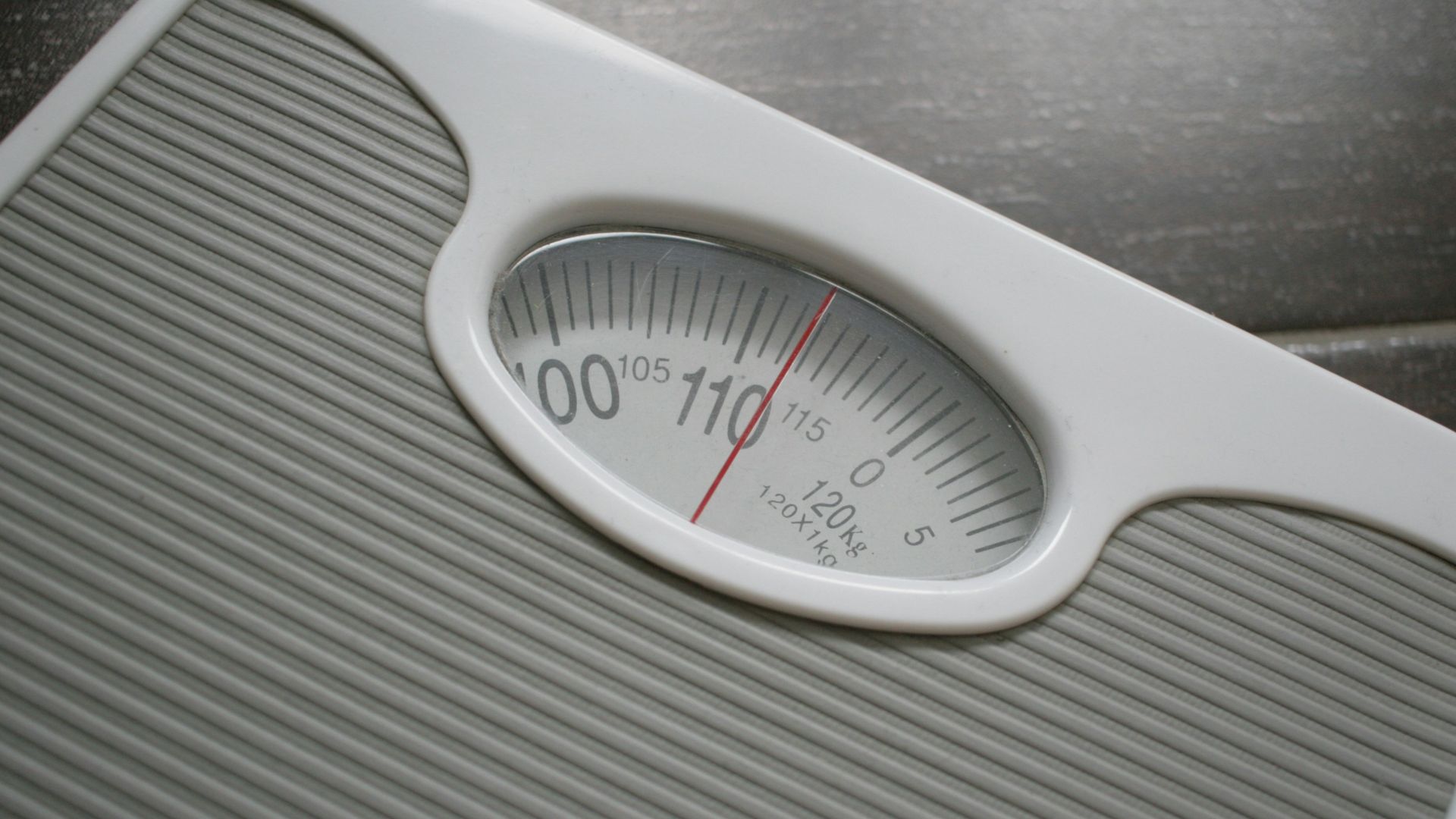 a bathroom scale sitting on top of a wooden table