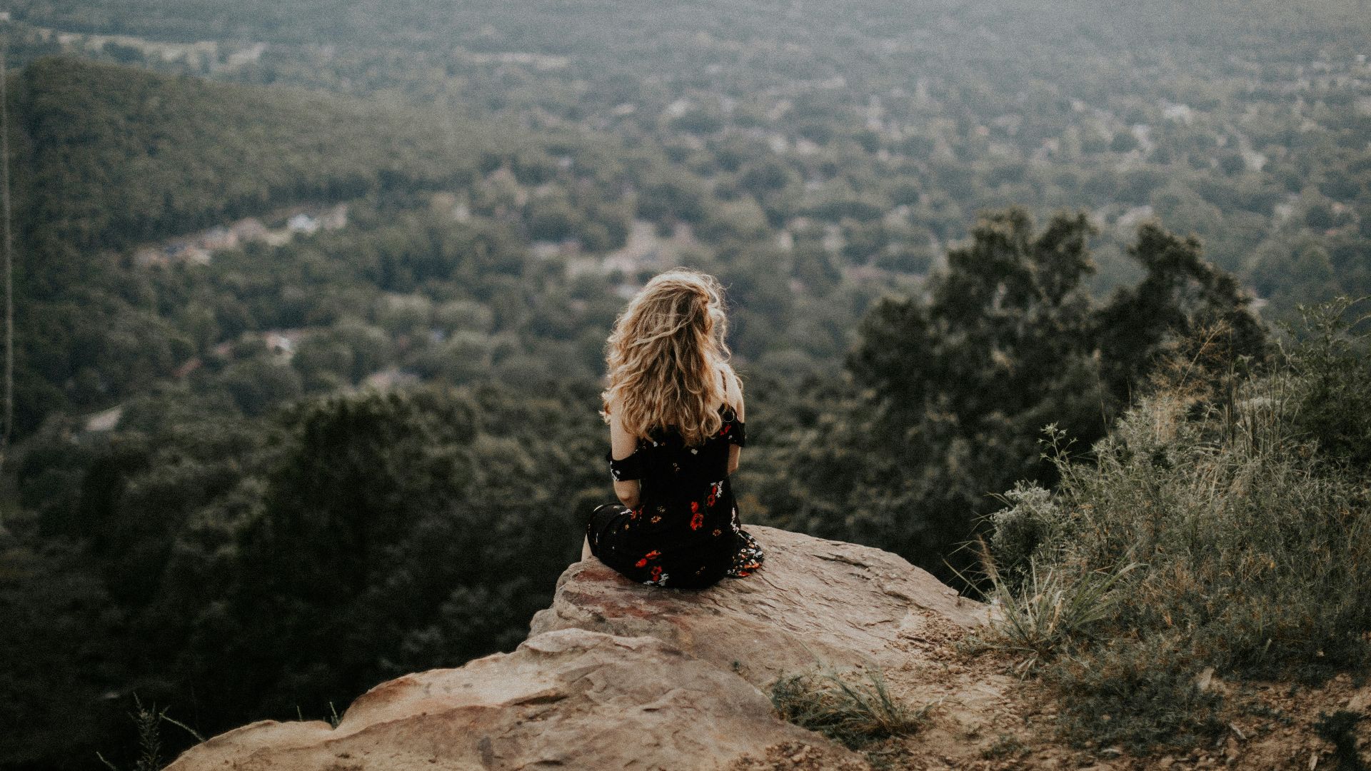 woman siting on cliff