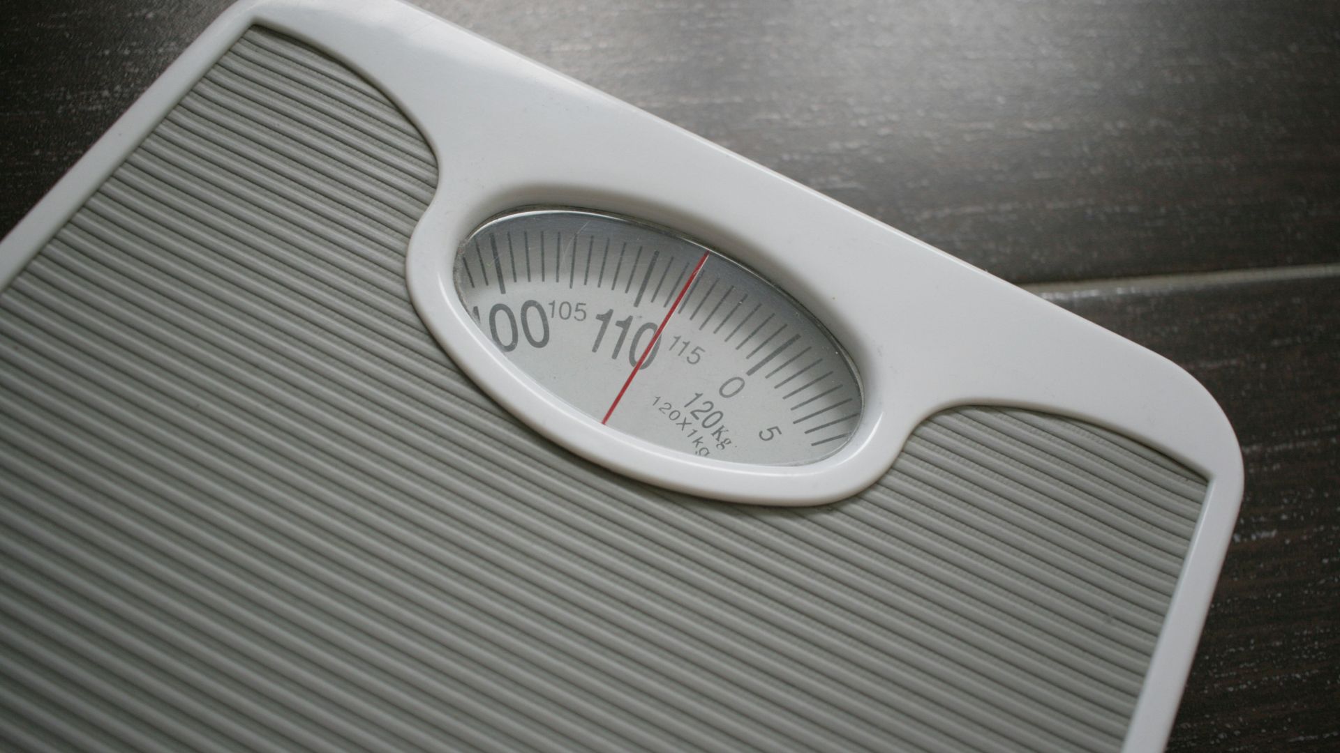 a bathroom scale sitting on top of a wooden table