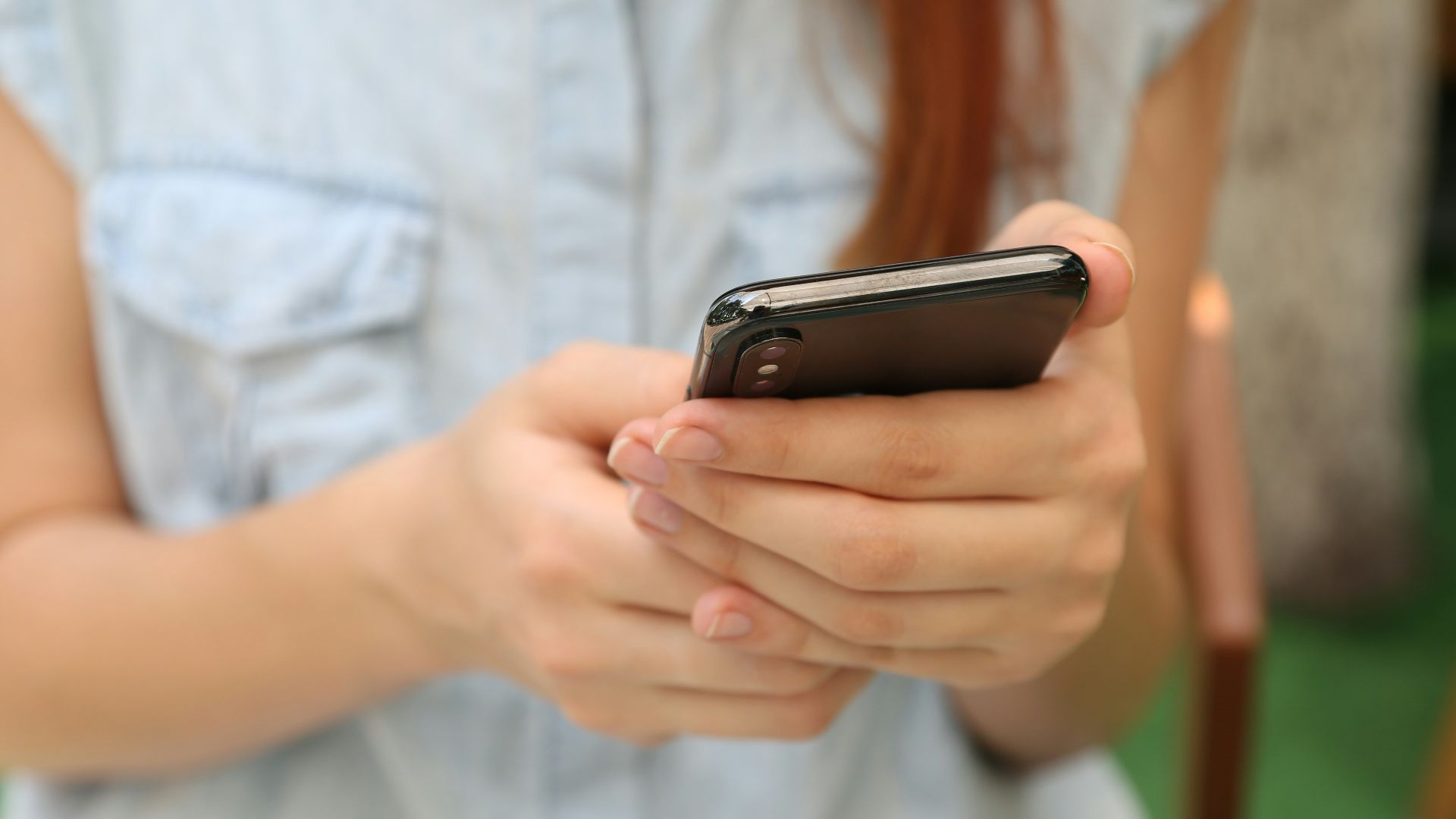 person holding using iPhone X