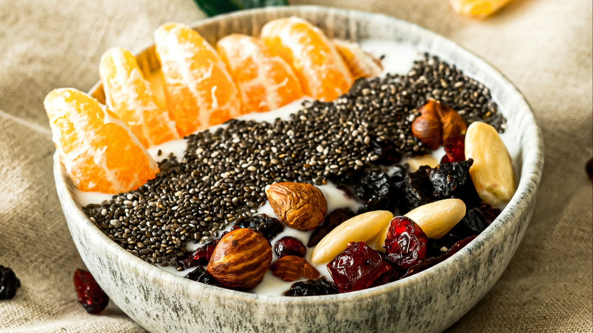 a bowl filled with fruit and nuts on top of a table