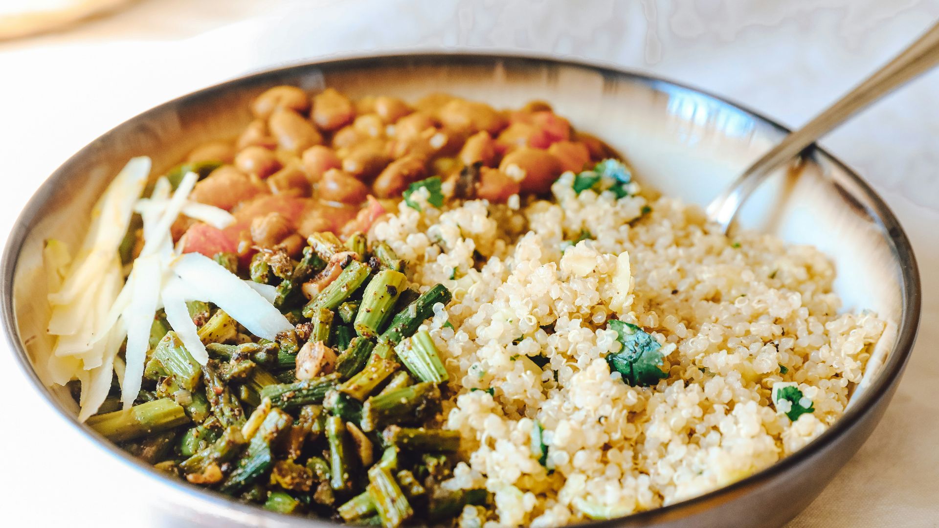 cooked rice with green peas and carrots on stainless steel bowl