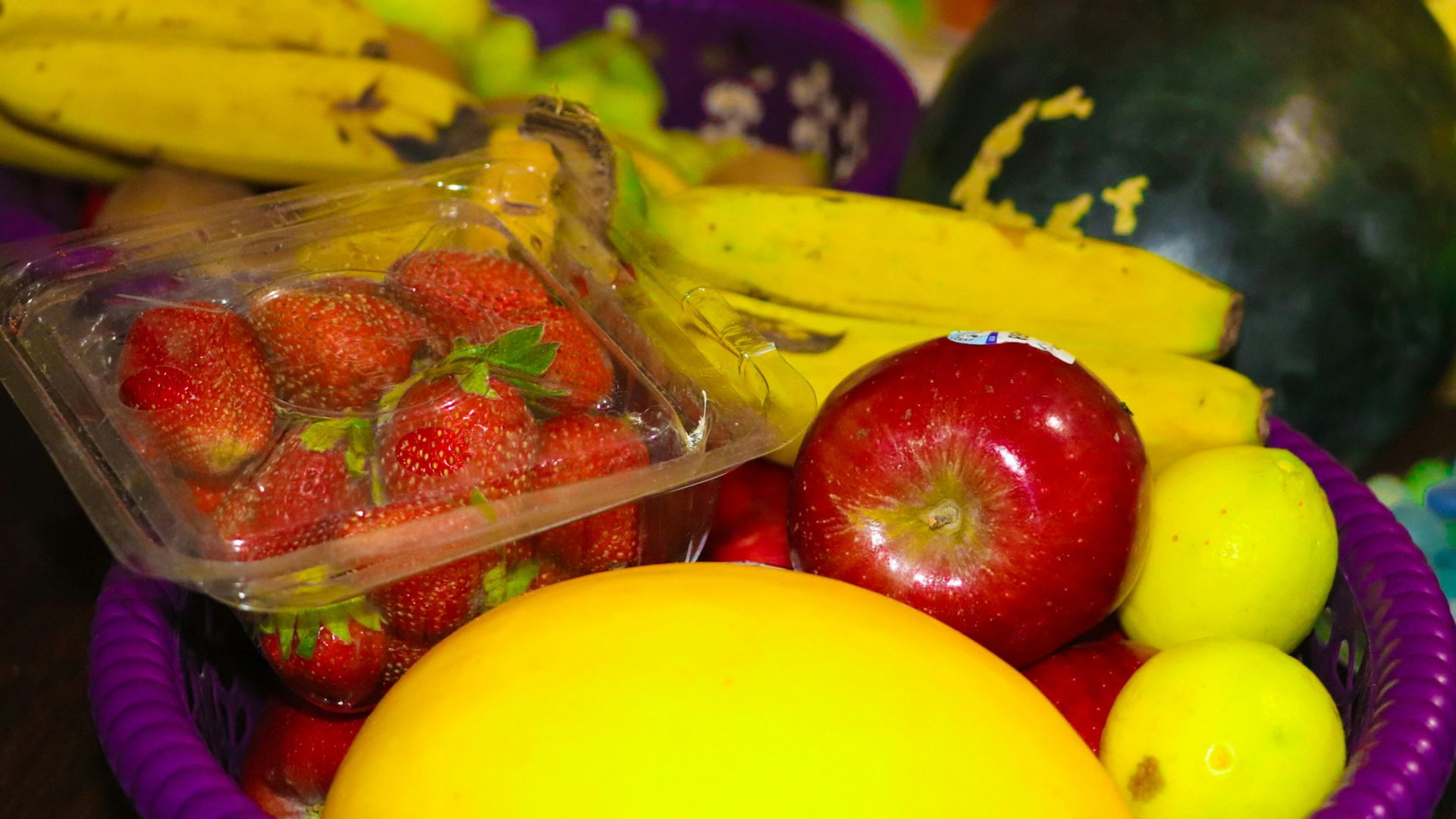 red strawberries on clear plastic container