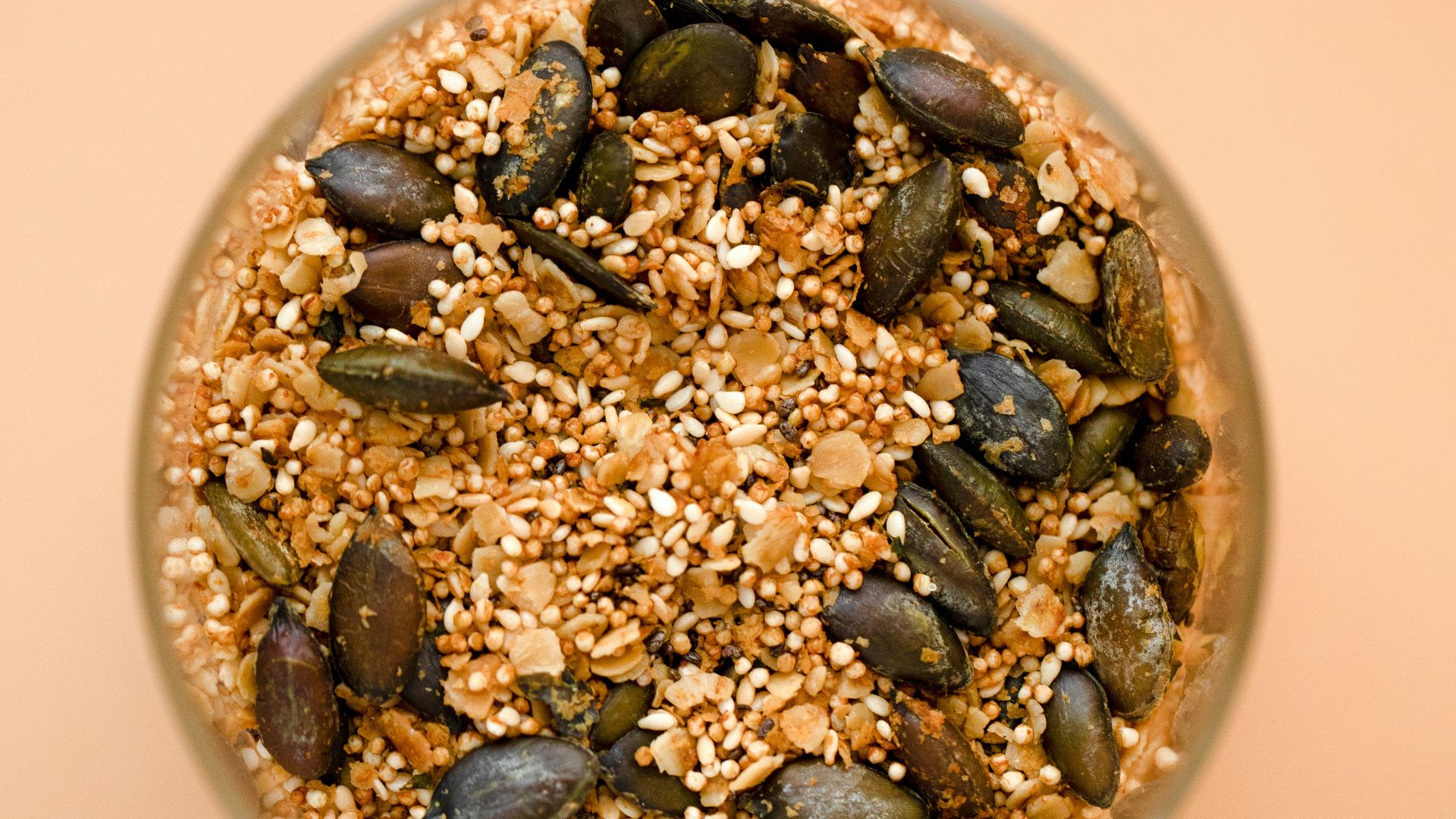 a glass bowl filled with seeds and seeds on top of a table