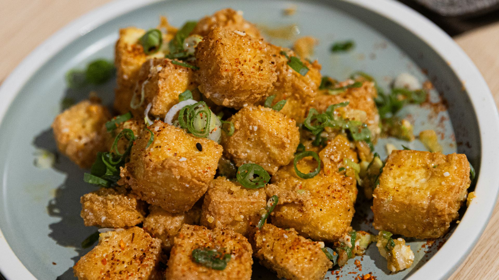 Crispy fried tofu cubes sprinkled with green onions