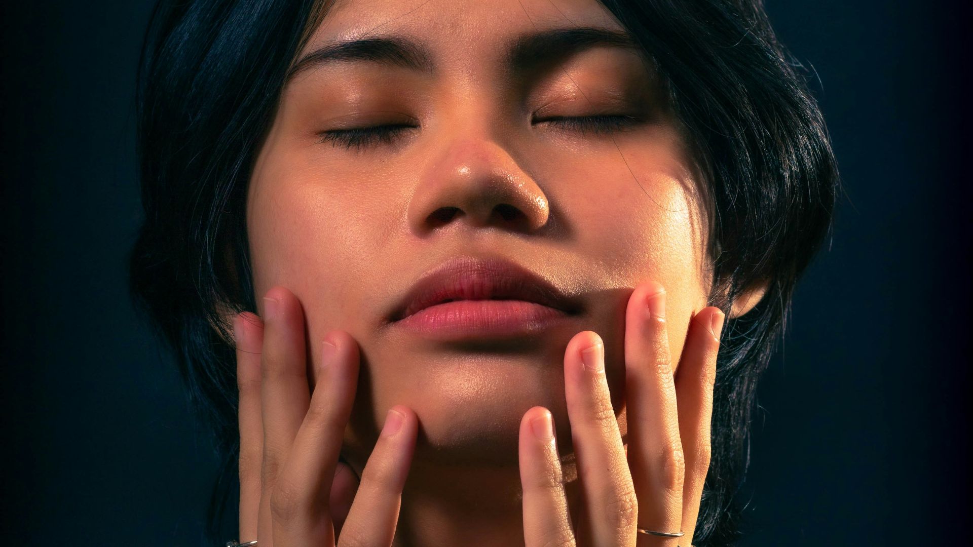 a woman with her hands on her face