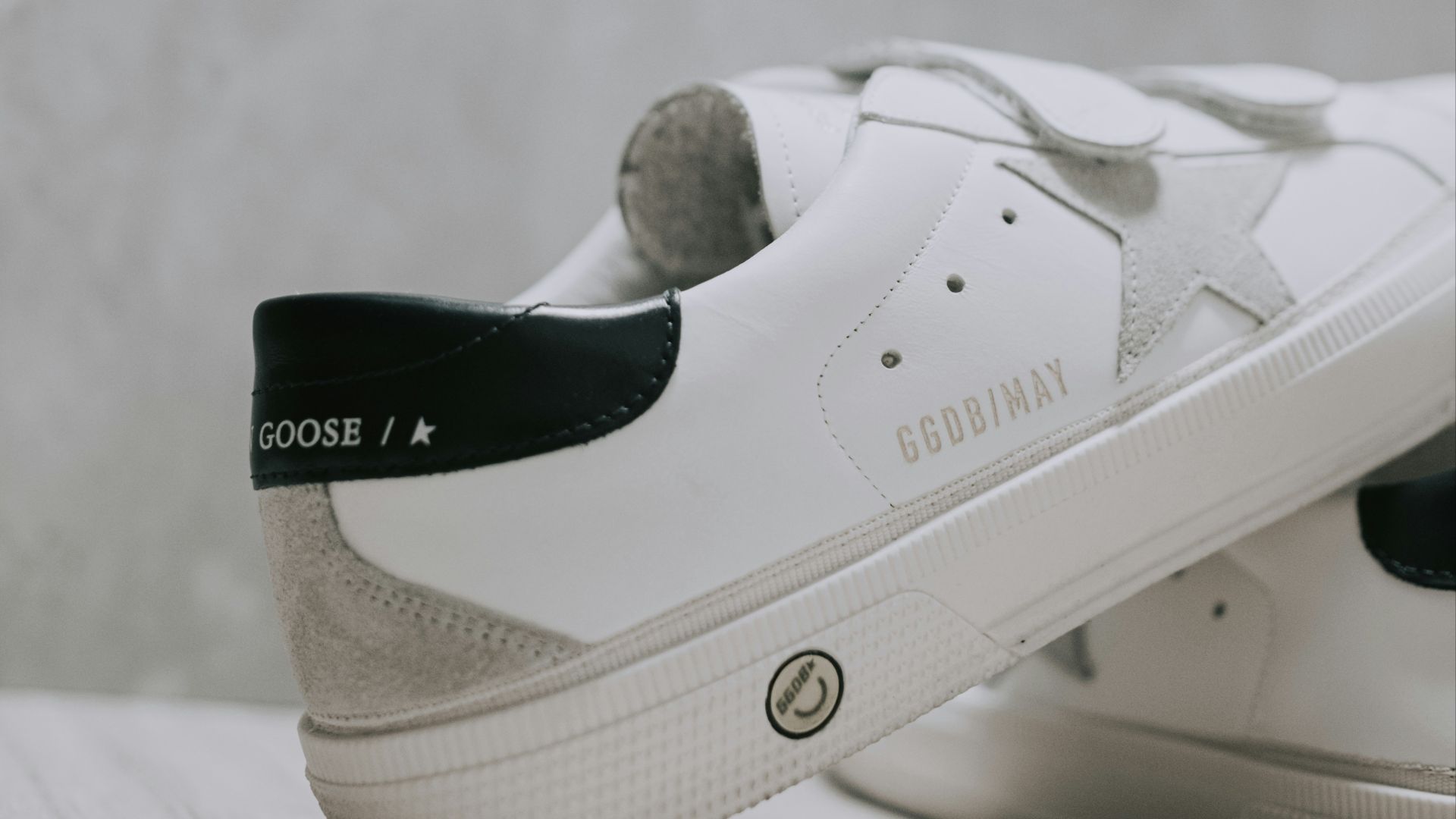 A pair of white sneakers with black laces